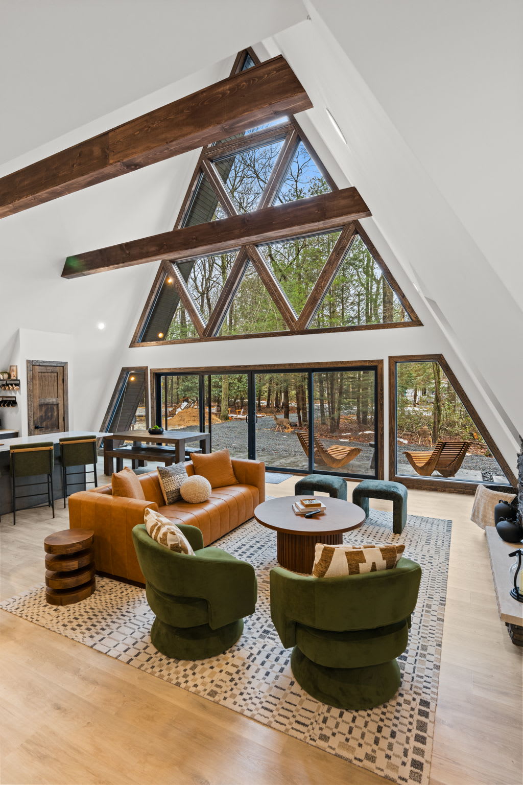 Gather around the long wooden dining table with breathtaking A-frame views.
