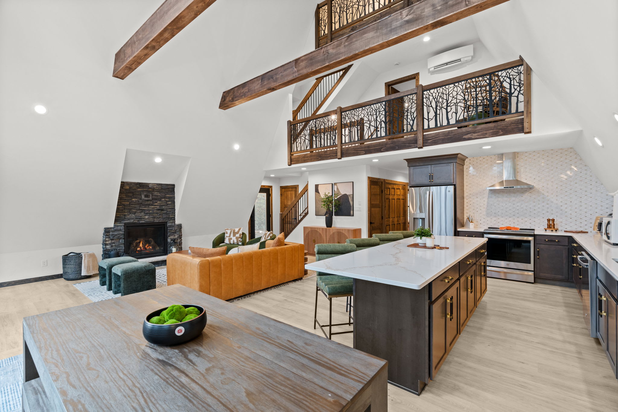 Gather around the stone fireplace with the kitchen and loft steps away