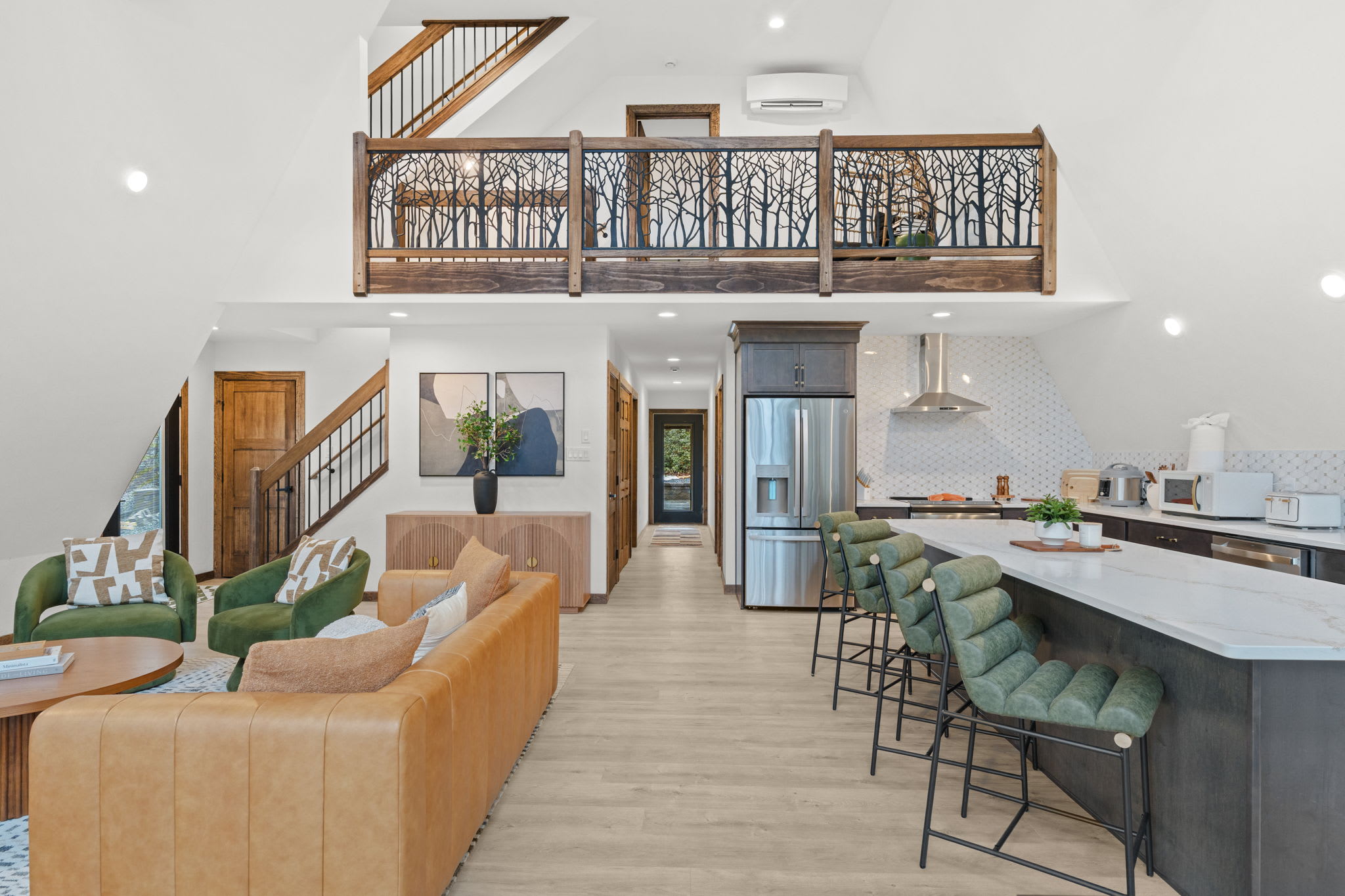 Whip up a meal in the modern kitchen with bar seating and forest views.