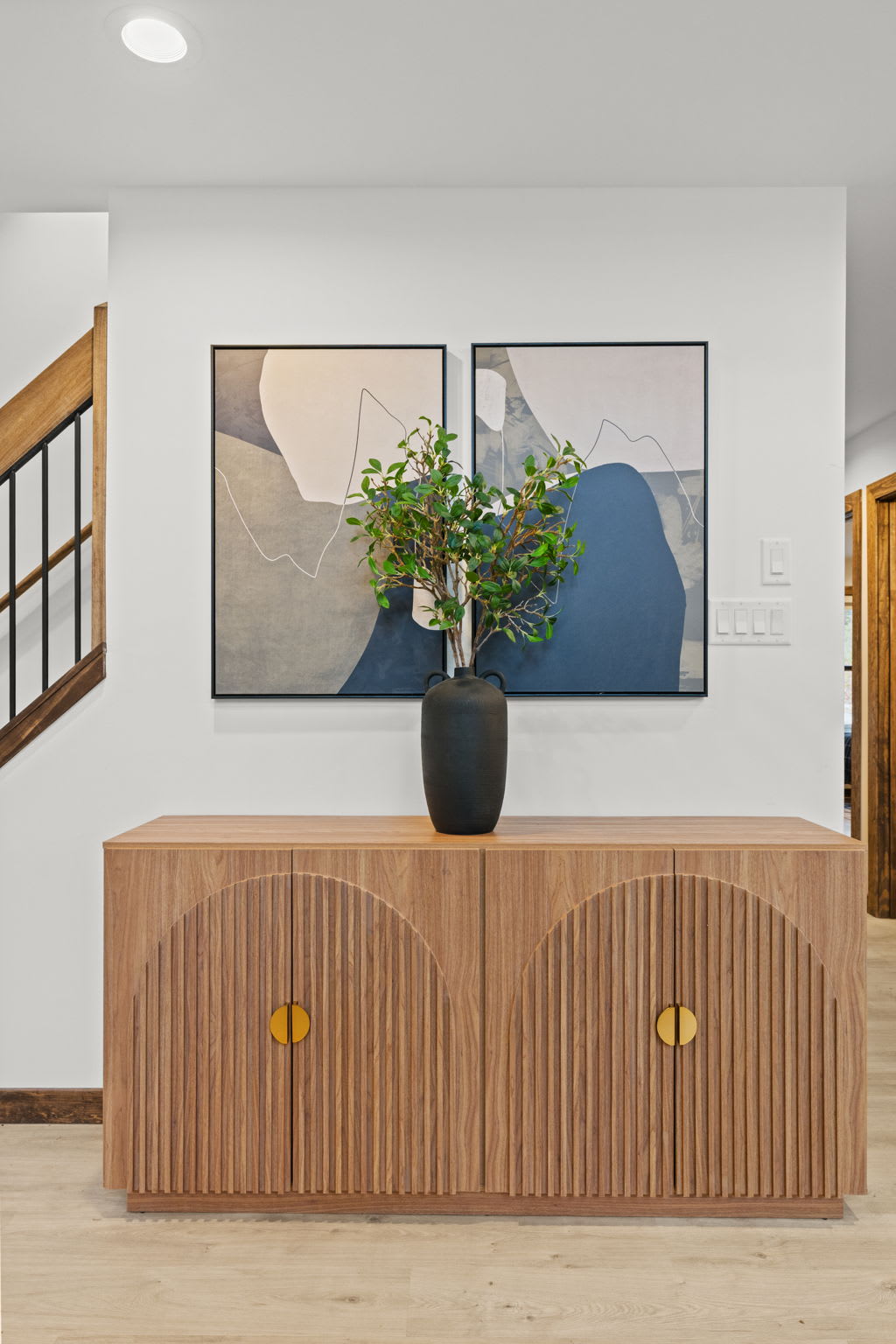 Stylish sideboard adds a touch of mid-century charm to the space.