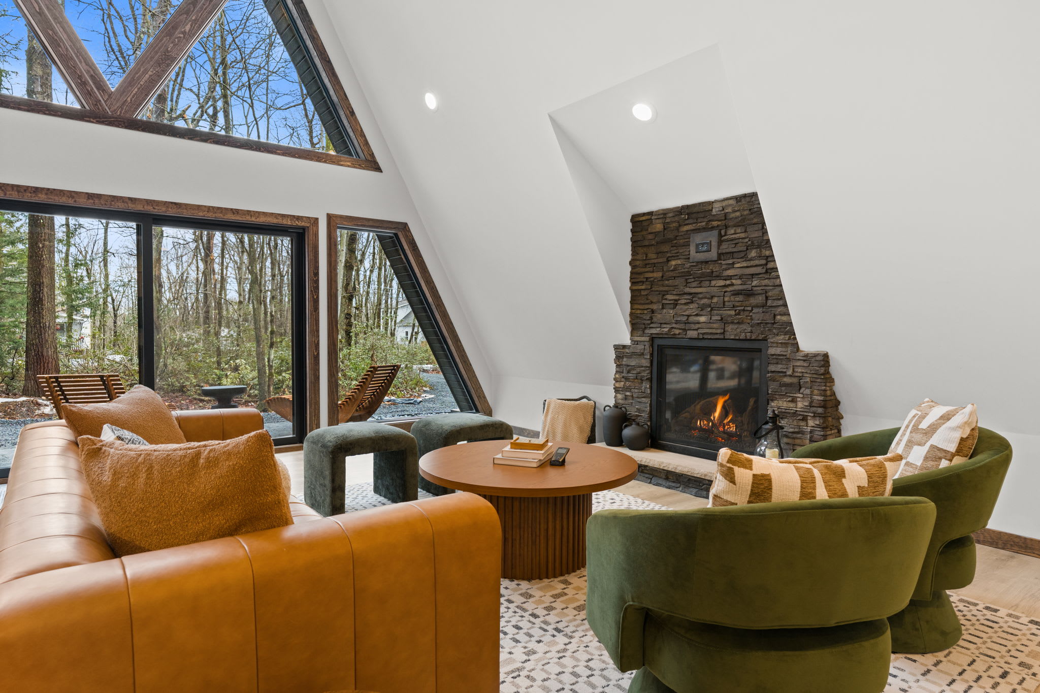 Warm leather seating faces the stunning wall of A-frame windows.