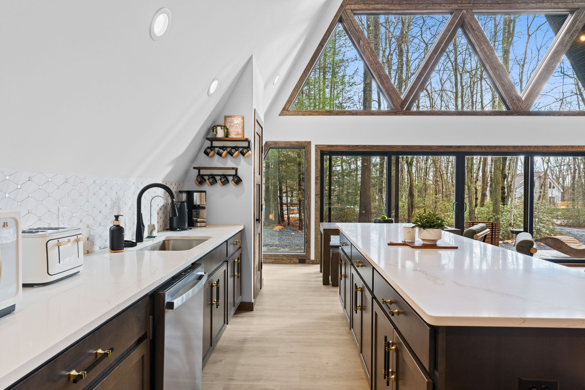 Natural light pours through the dramatic A-frame windows into the open living space.