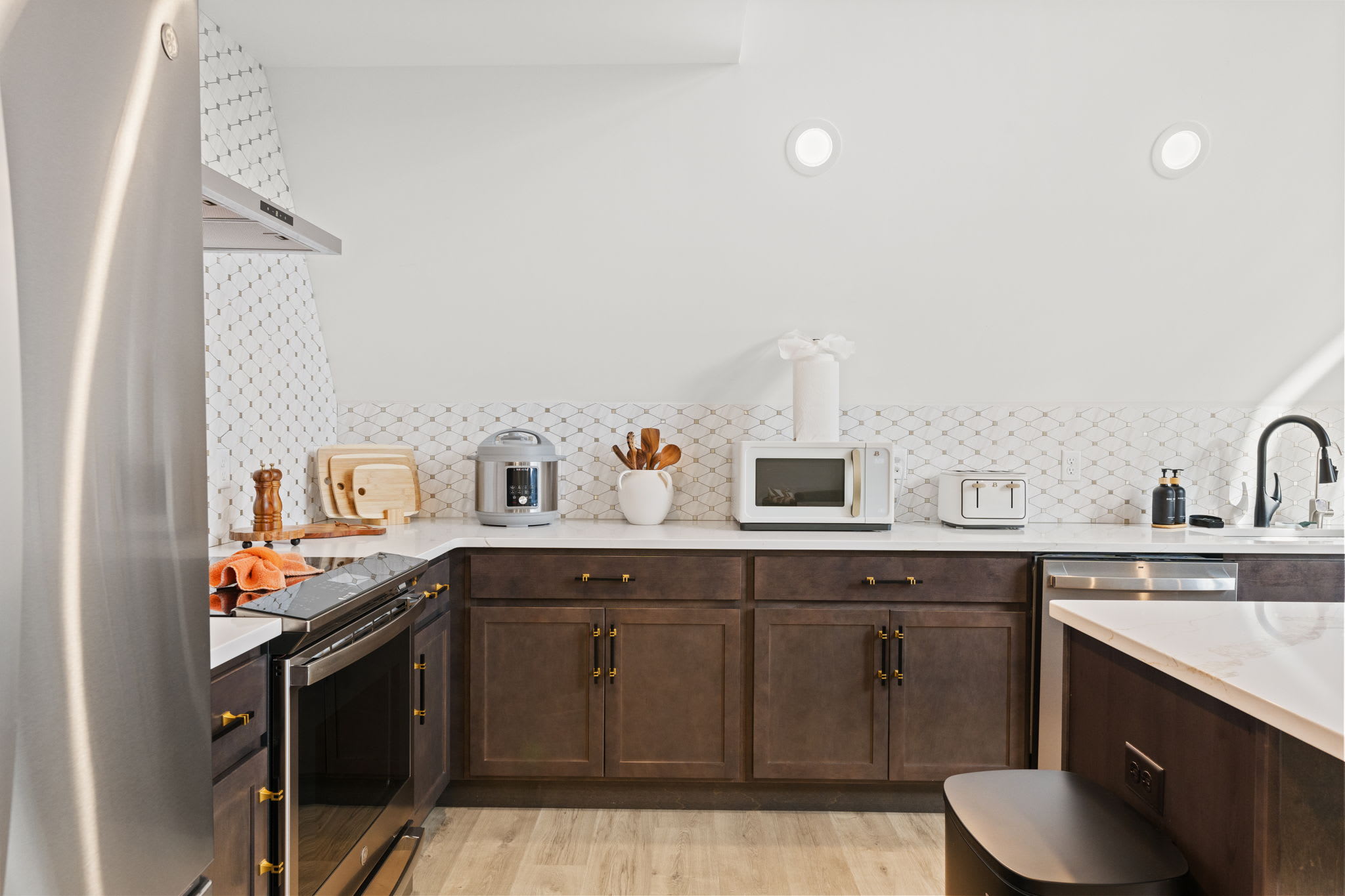 Fully equipped kitchen with navy cabinetry and modern stainless steel appliances