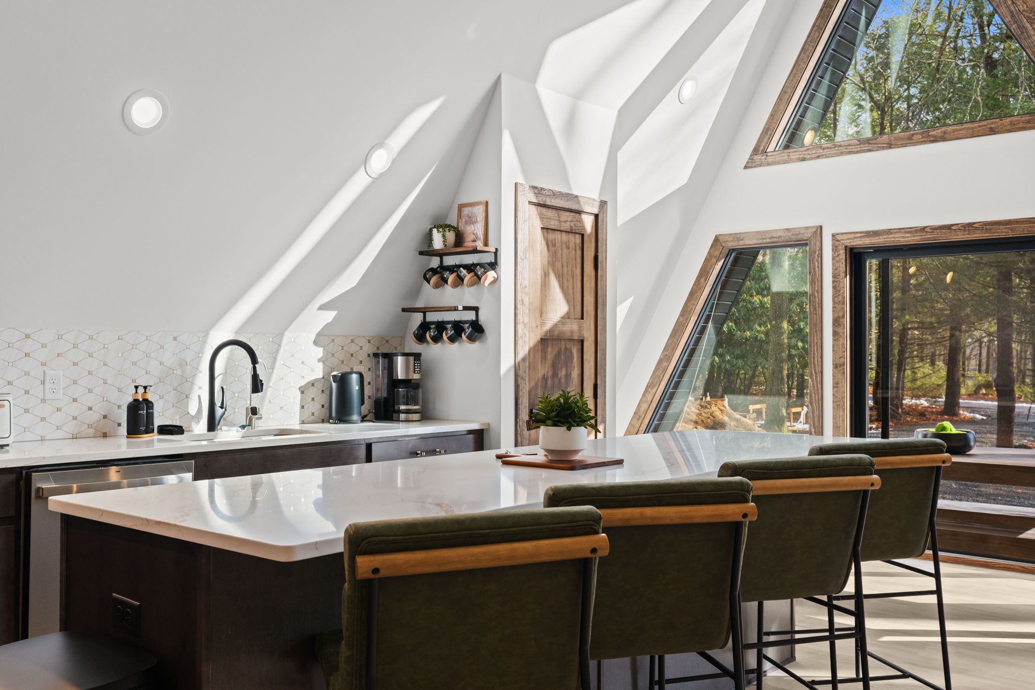 Enjoy meals at the long dining table with stunning A-frame views.