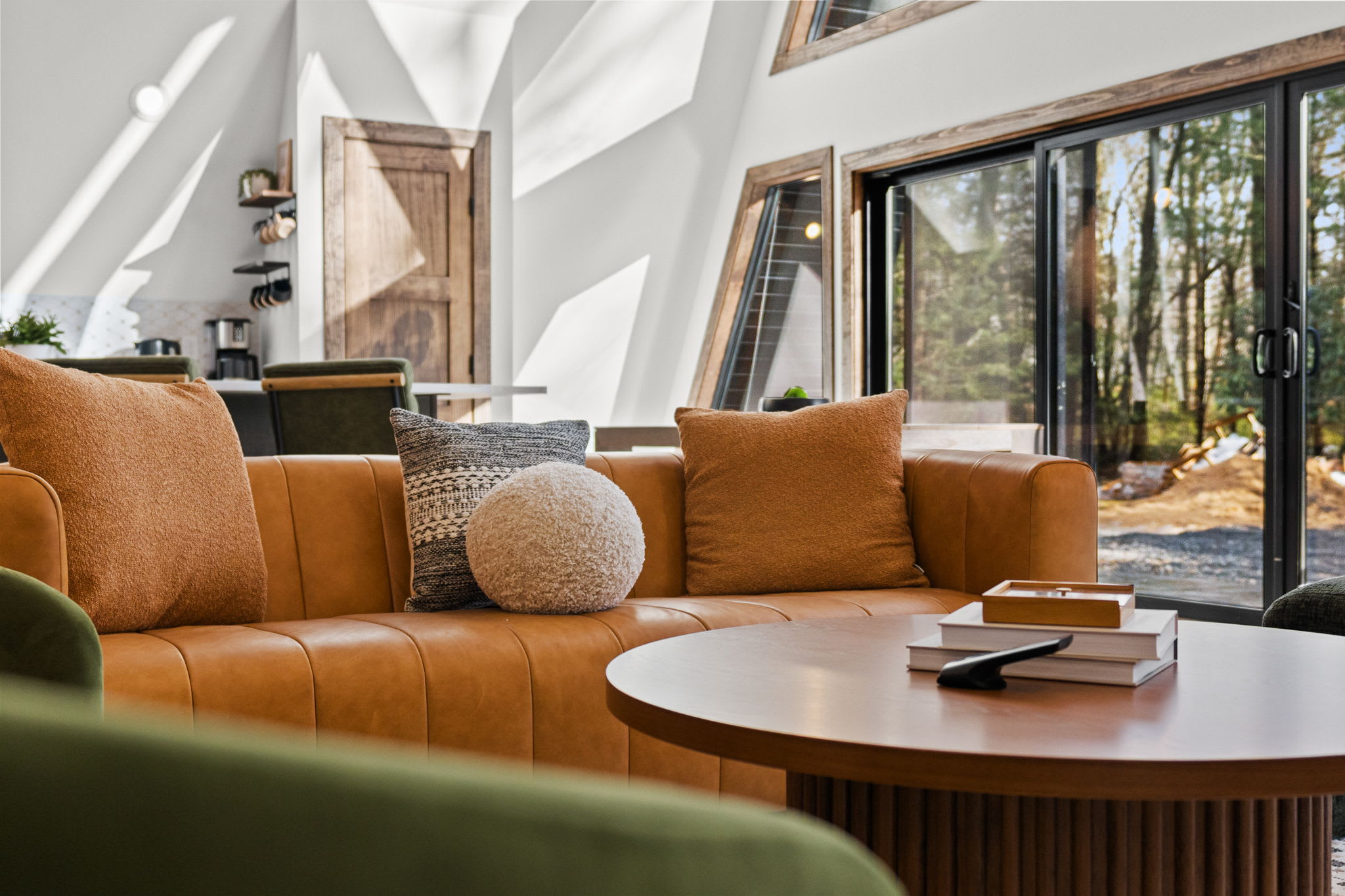 Sink into the leather sofa beneath soaring wood beams and A-frame windows.
