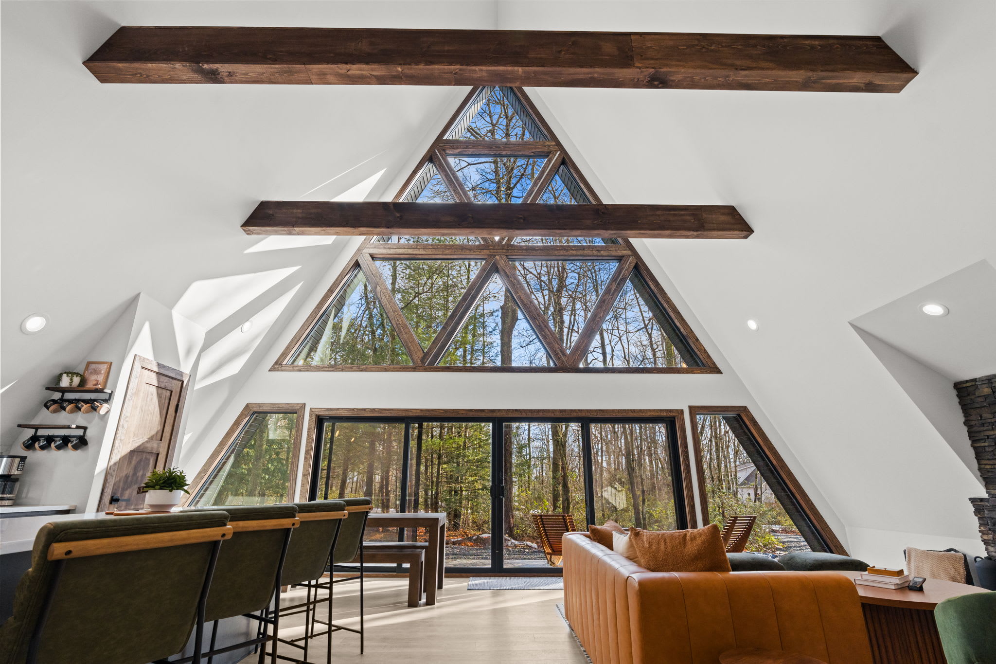 Marvel at the soaring wood beams and towering A-frame windows above.