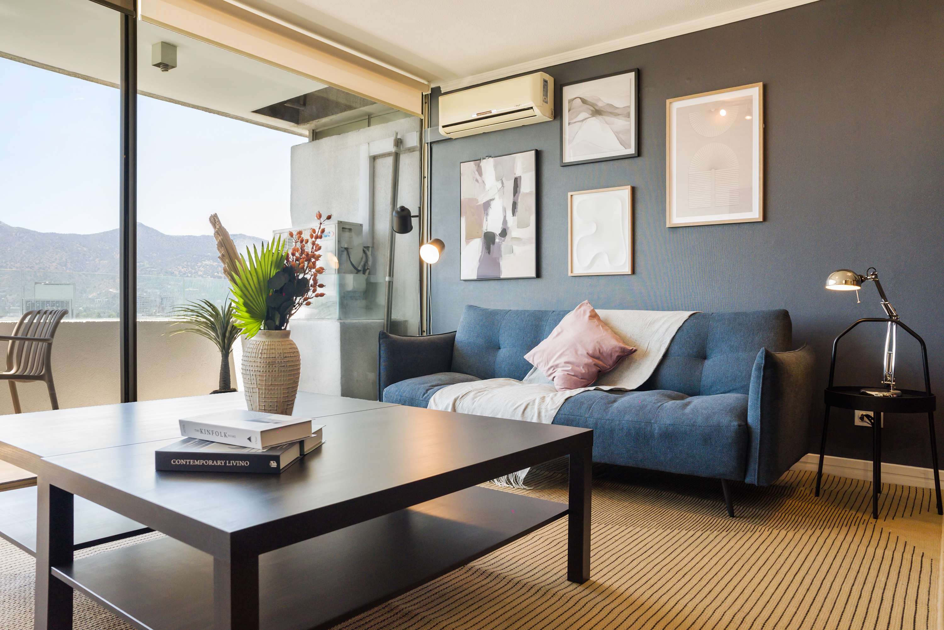 Relax in this stylish living room with stunning mountain views and modern decor.
