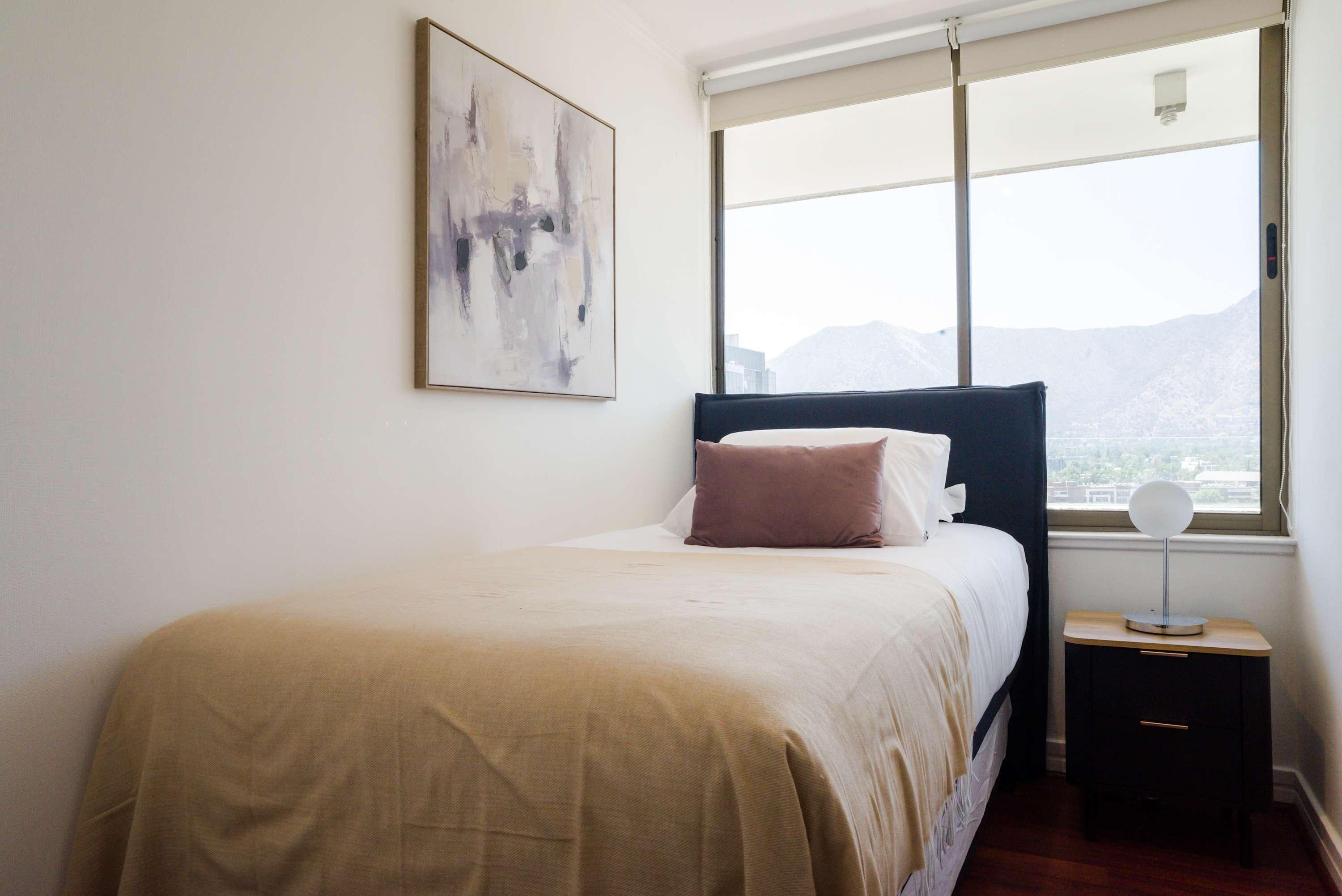 Cozy bedroom with stunning mountain views, perfect for a relaxing stay.