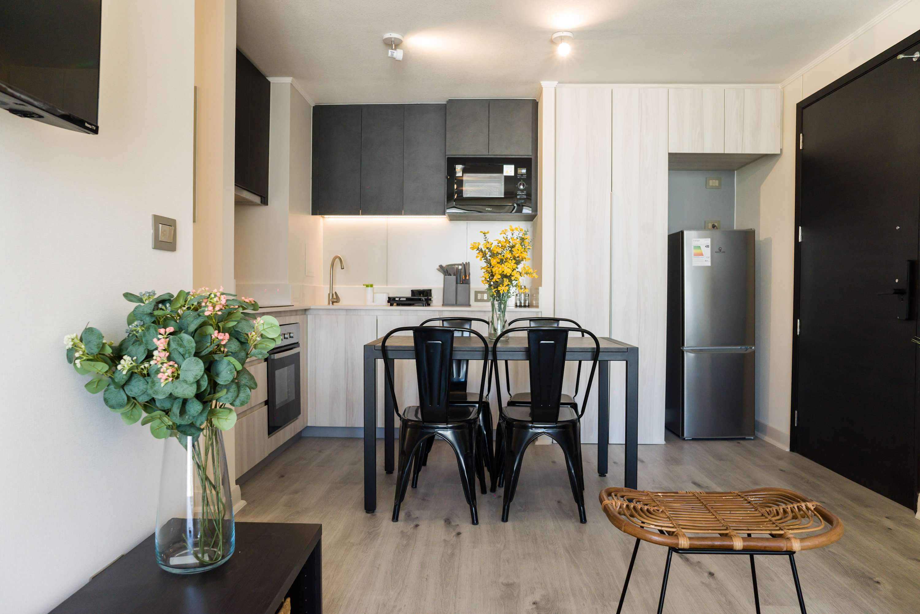 Modern kitchen with sleek appliances and a stylish dining area, perfect for enjoying a meal at home.