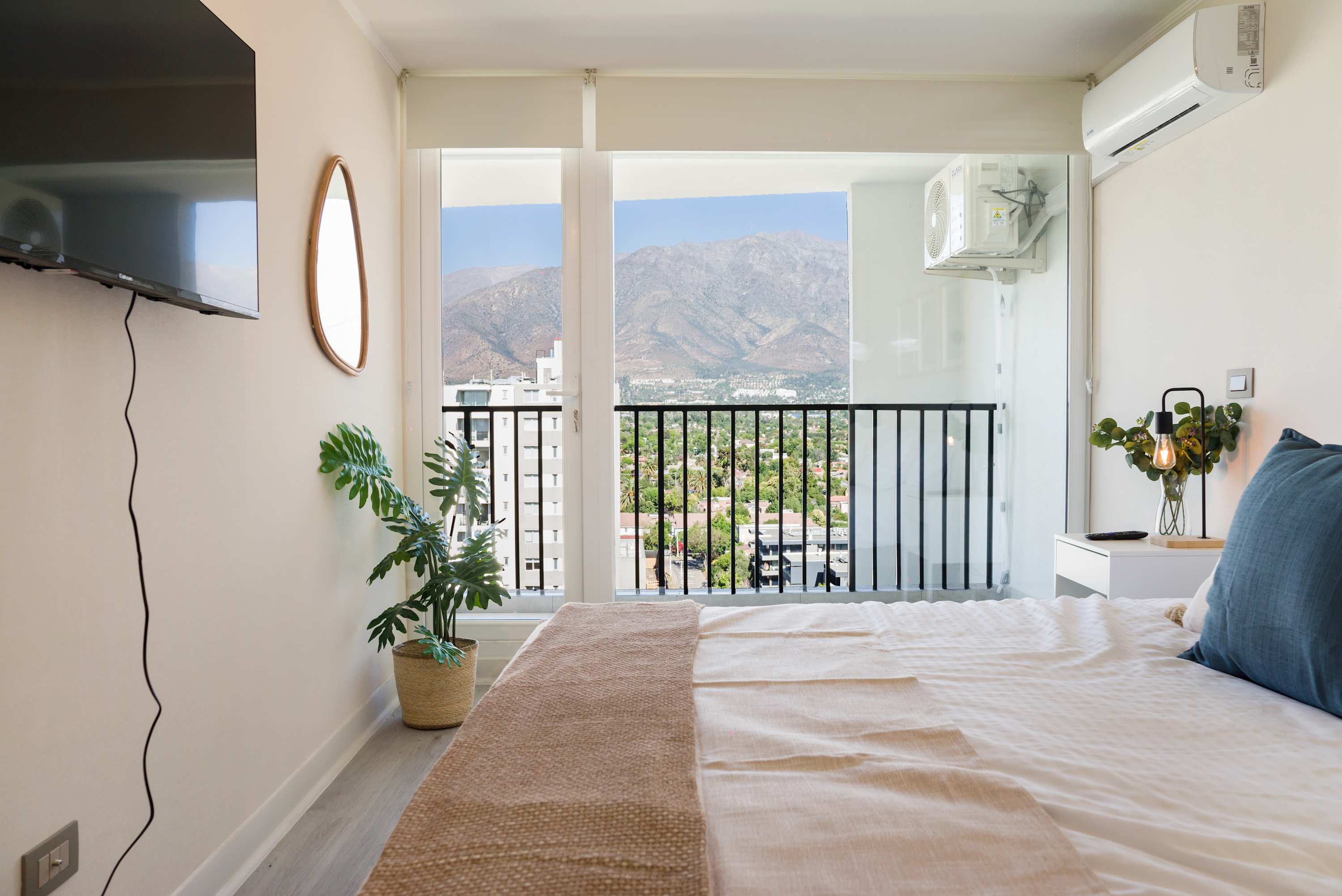 Cozy bedroom with stunning mountain views, perfect for unwinding after exploring Santiago.