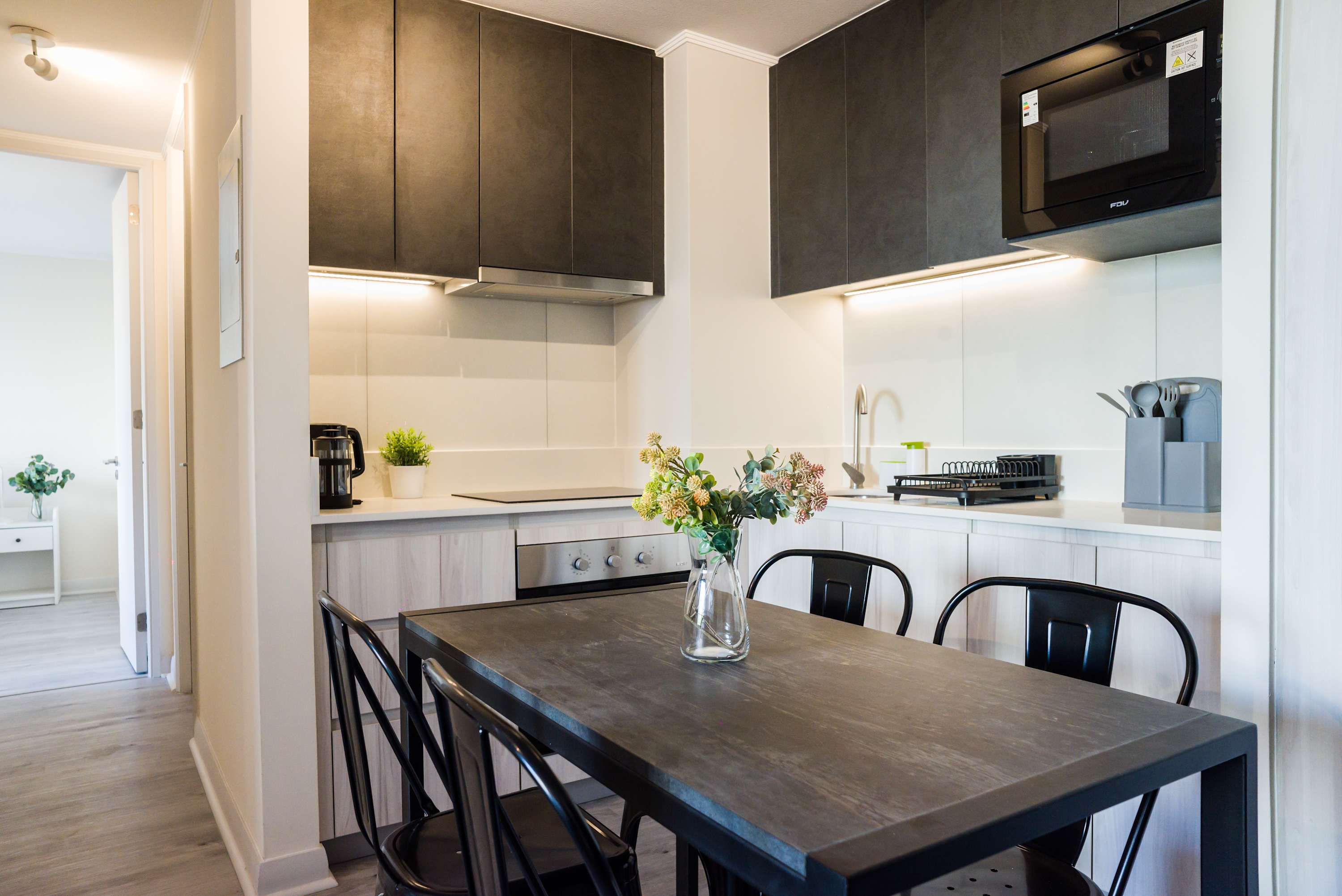 Modern kitchen and dining area with sleek design, perfect for stylish meals.