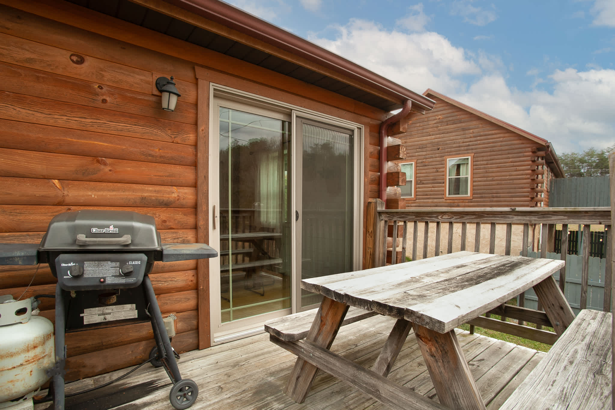 Enjoy a cookout on the deck with our Char-Broil gas grill and rustic wooden picnic table.