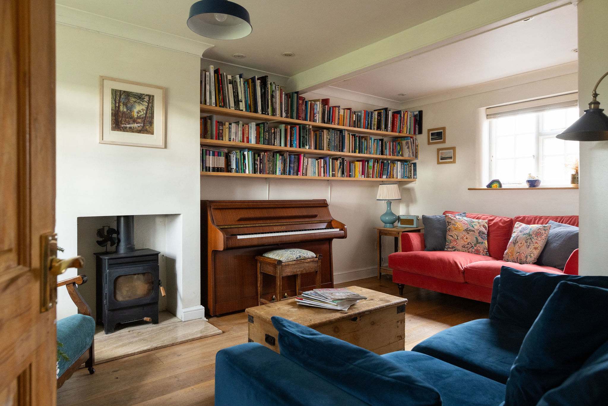 Welcoming lounge with wood-burning stove and piano