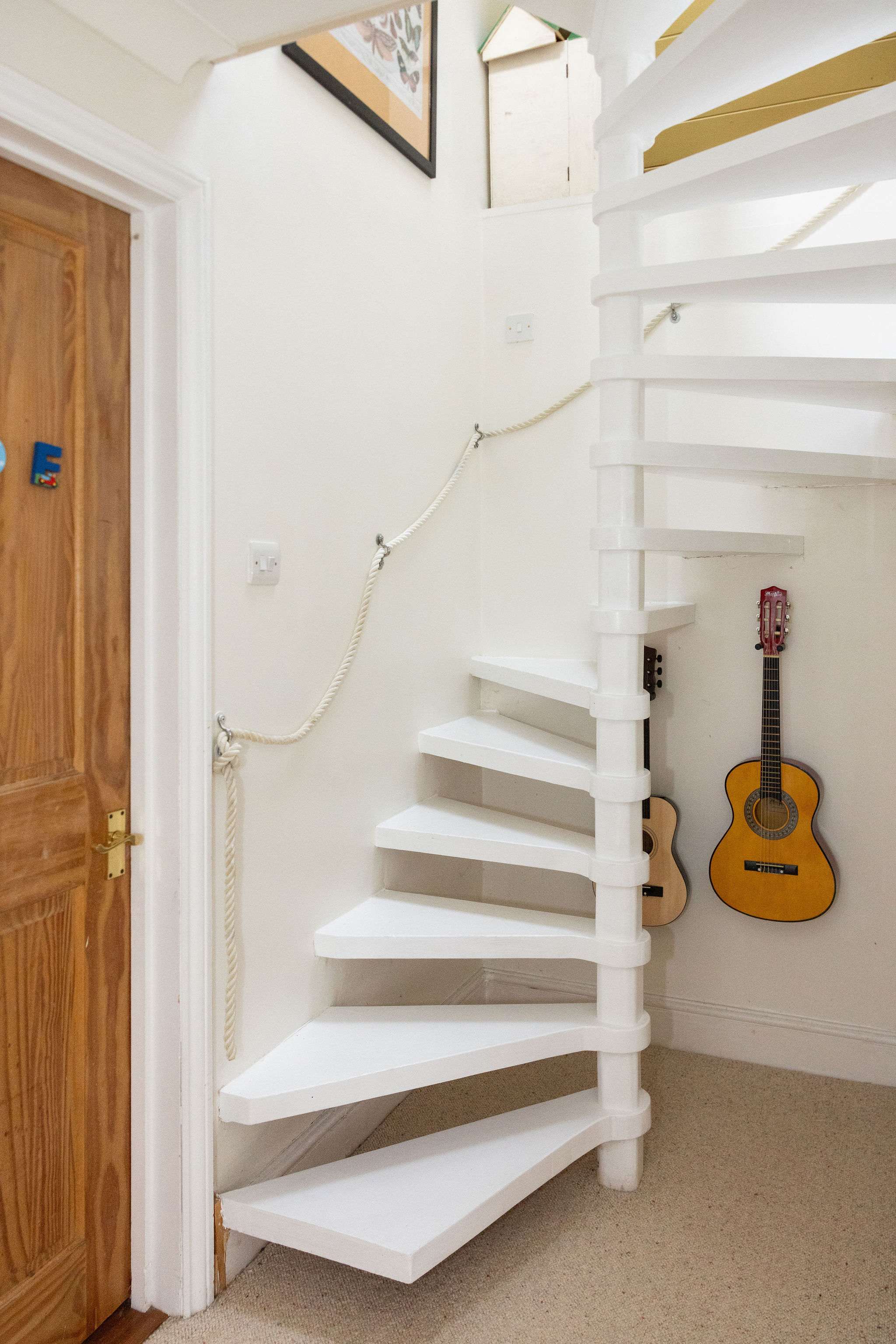 Spiral staircase up to the third floor, keep fit area and 3rd bedroom