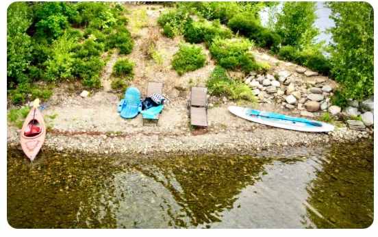 The public shared beach at Loon Point.  Seating for humans. Commentary by loons.