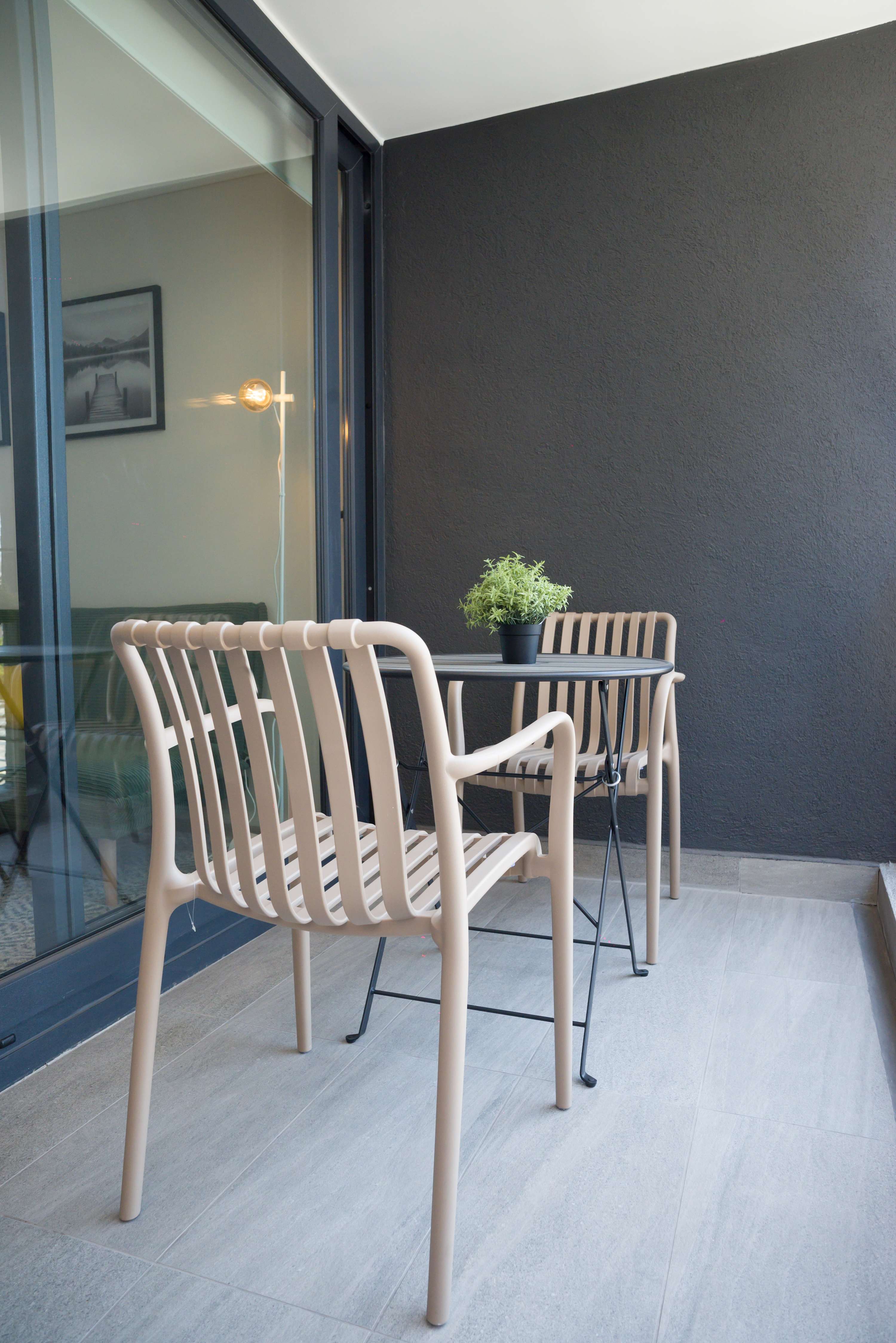 Charming balcony with seating for two, ideal for sipping coffee and enjoying fresh air.