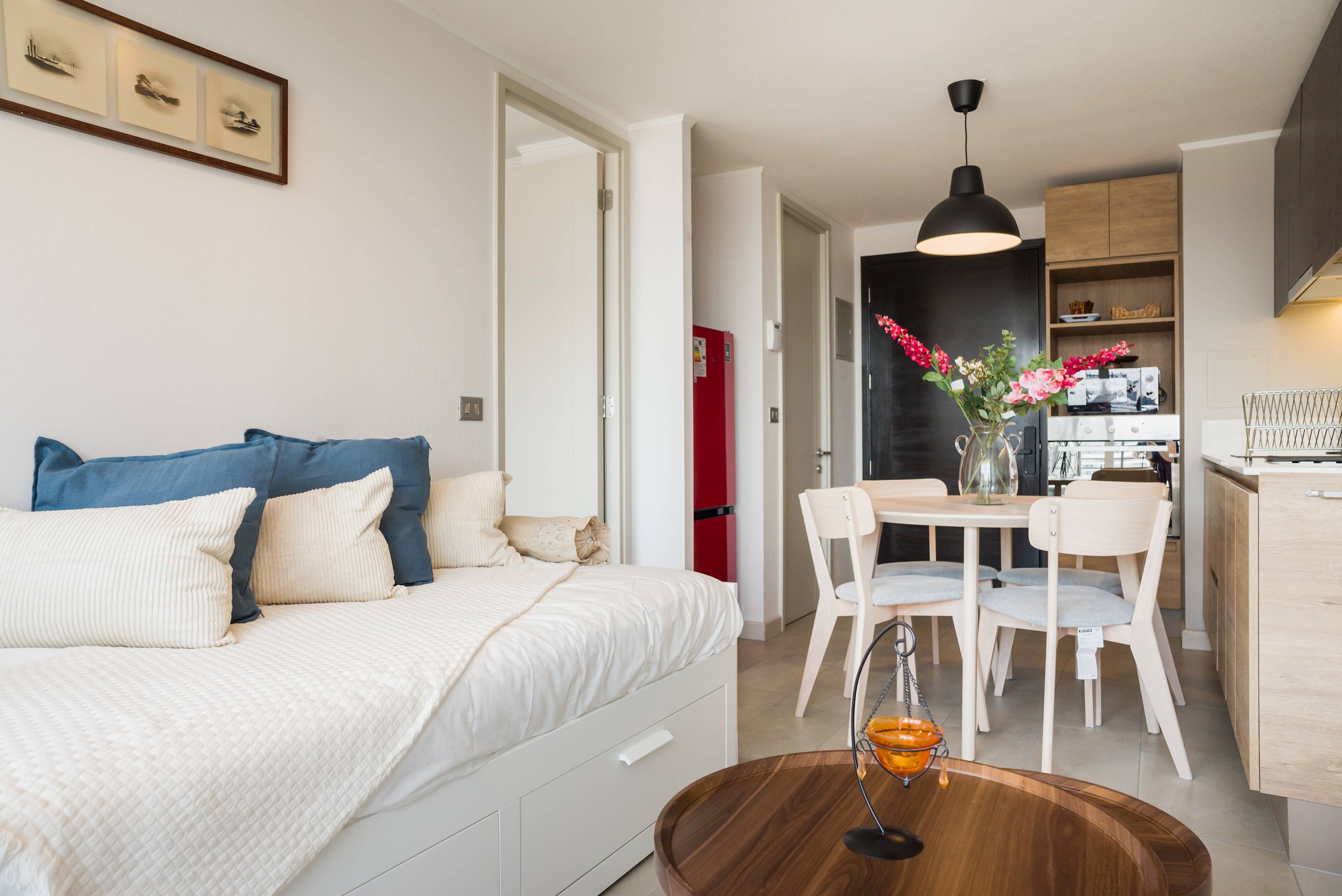 Bright and cozy living space with a stylish dining area and modern kitchen, perfect for relaxation and dining.