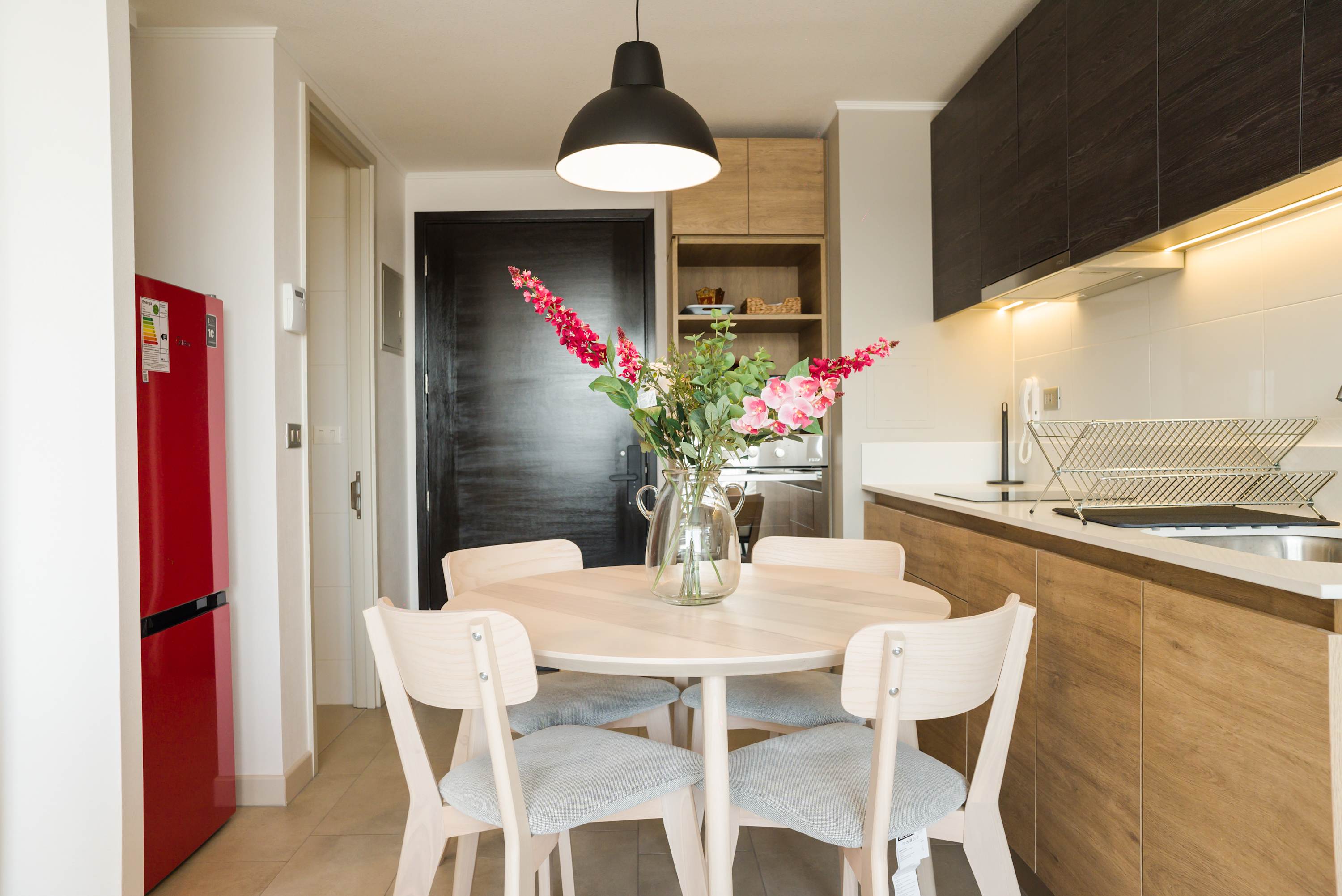 Cozy dining area with stylish decor and modern kitchen amenities, perfect for intimate meals.