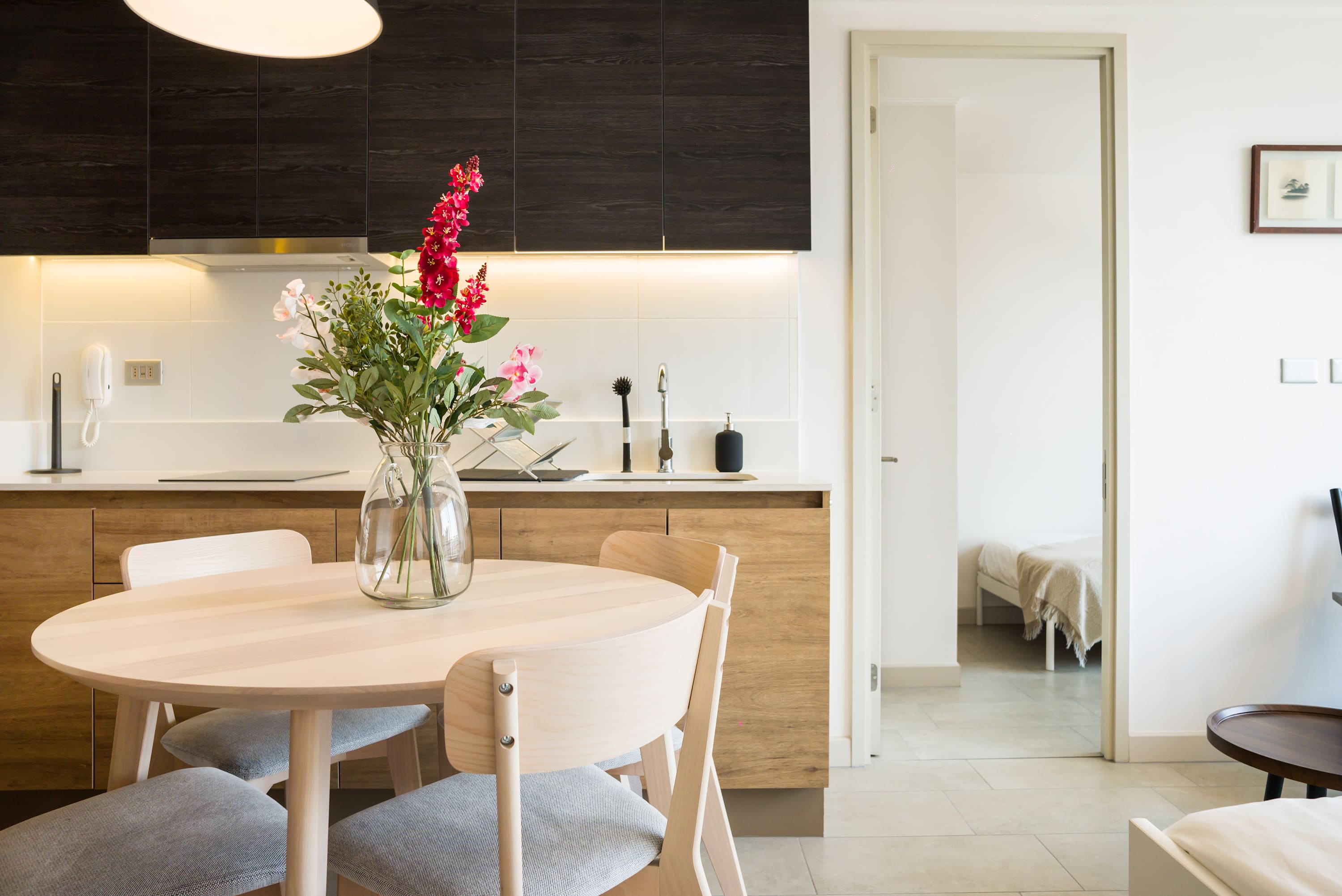 Cozy kitchen with modern amenities and a charming dining area, perfect for intimate meals.