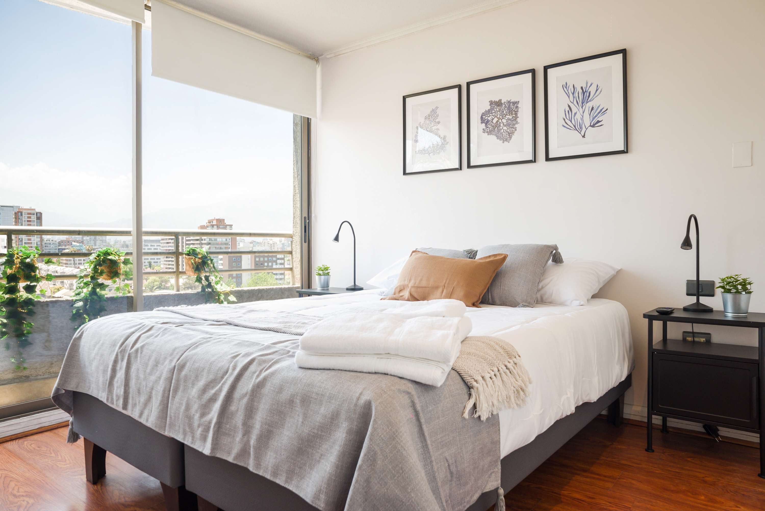Relax in this stylish bedroom with stunning city views, chic decor, and a cozy ambiance perfect for unwinding.