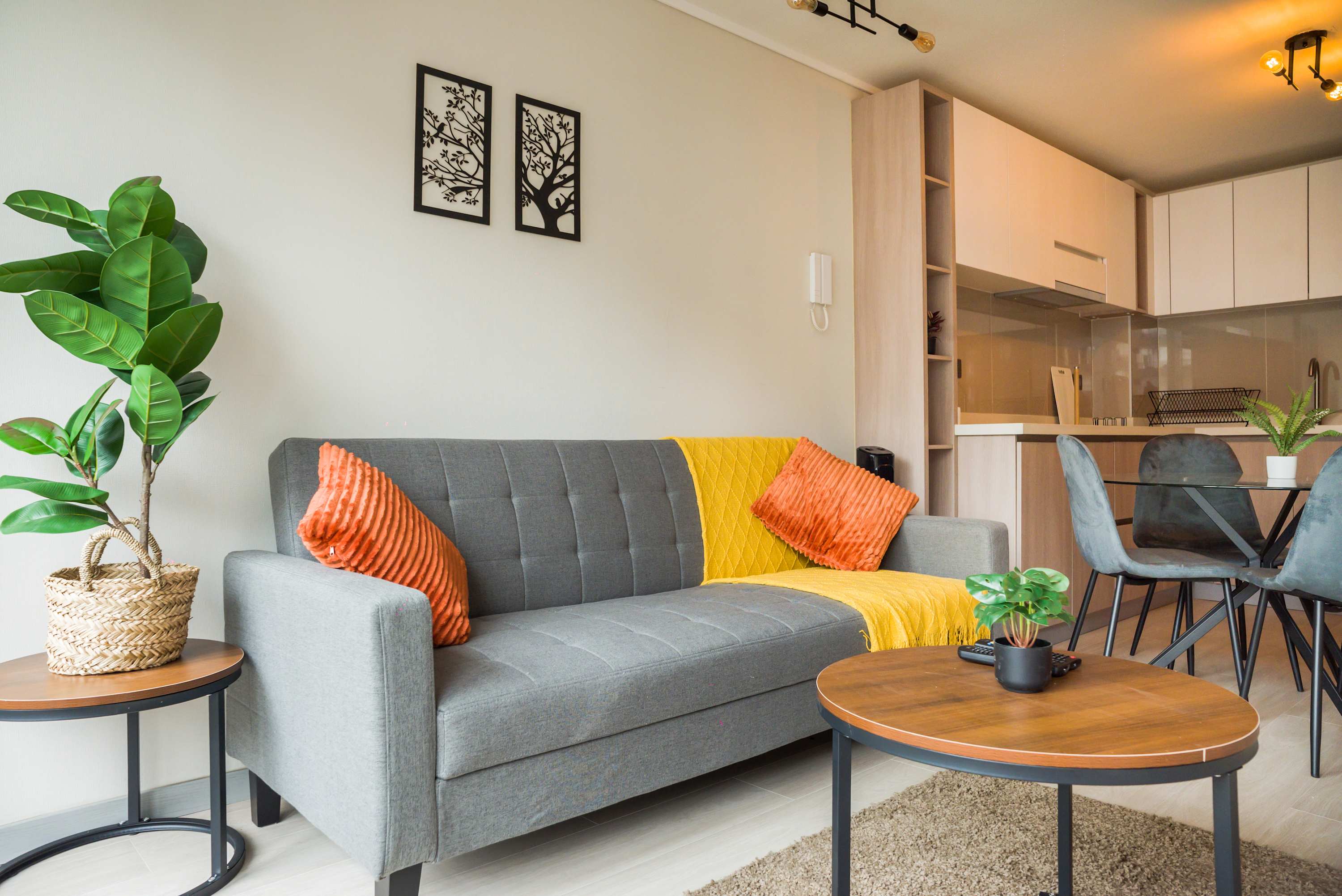 Bright and stylish living area with modern kitchen and cozy seating, perfect for relaxation and dining.