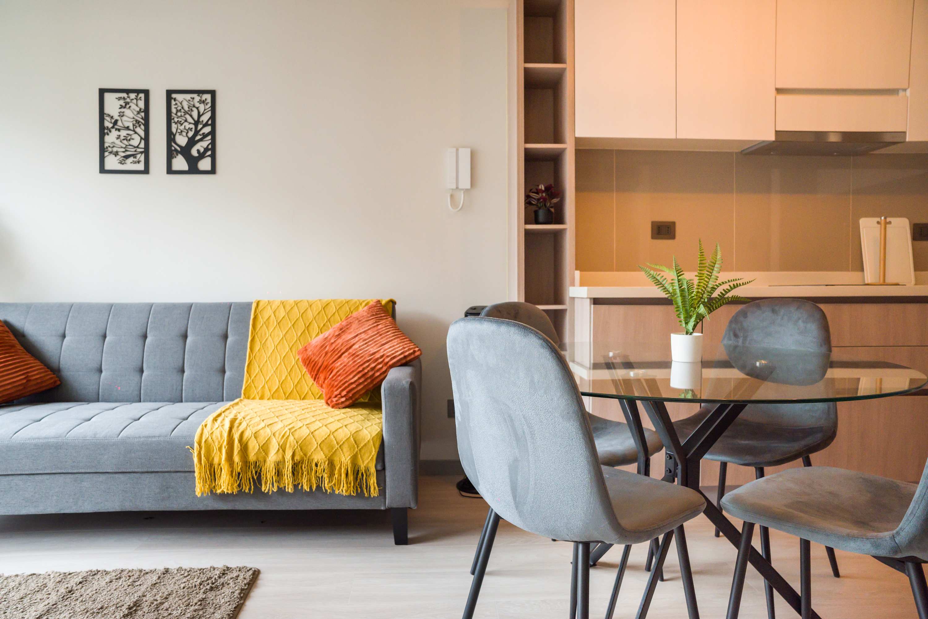 Cozy living space with stylish decor and a modern kitchen, perfect for relaxing or dining.