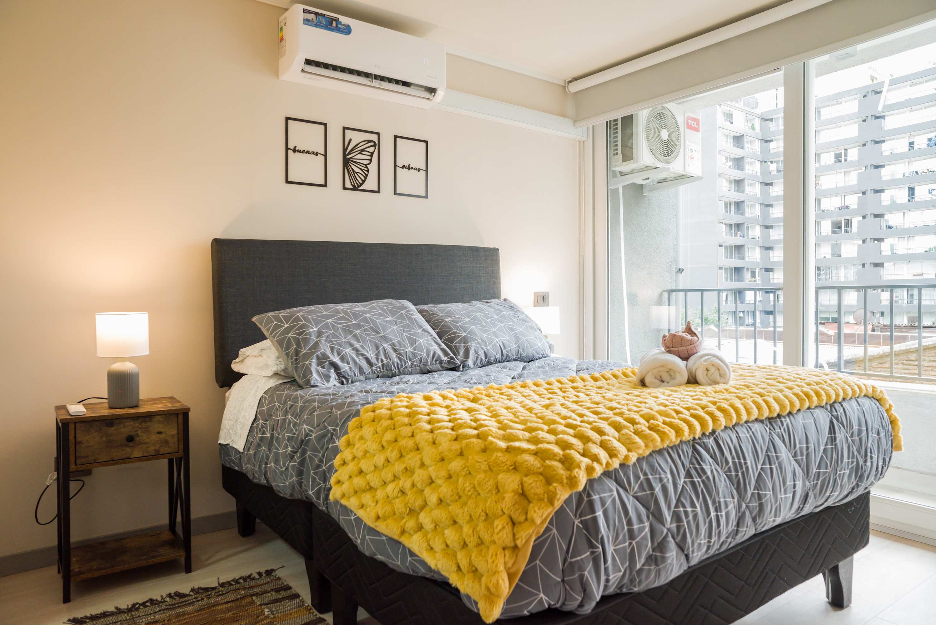 Relax in this cozy bedroom with a plush bed and vibrant decor, perfect for unwinding after exploring the city.