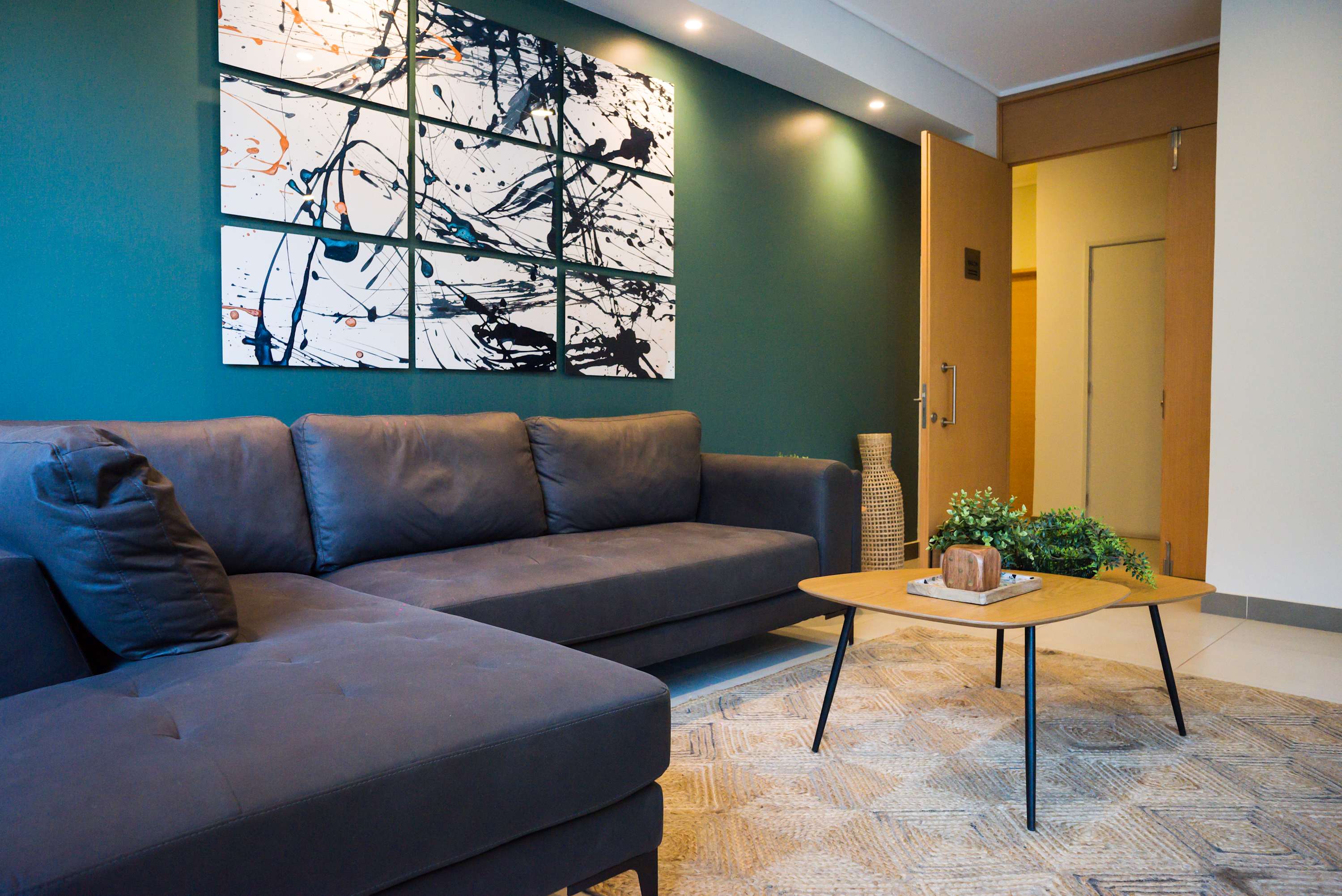 Relax in this stylish living area with a cozy sofa, vibrant art, and modern decor, perfect for unwinding after a day of exploring.