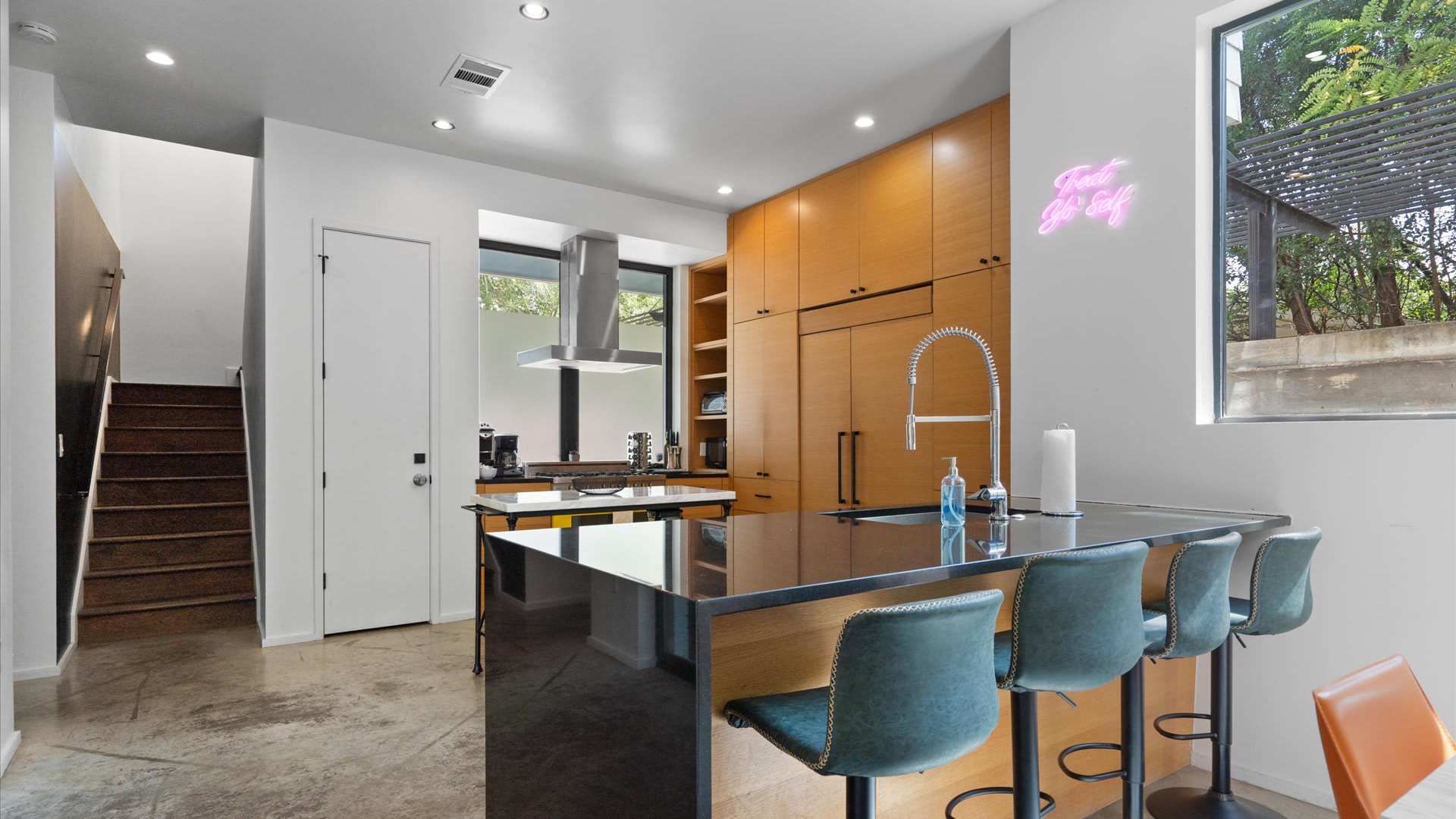 Stylish & Fully Equipped Kitchen - A sleek, contemporary kitchen with bar seating designed for both short stays and longer visits.