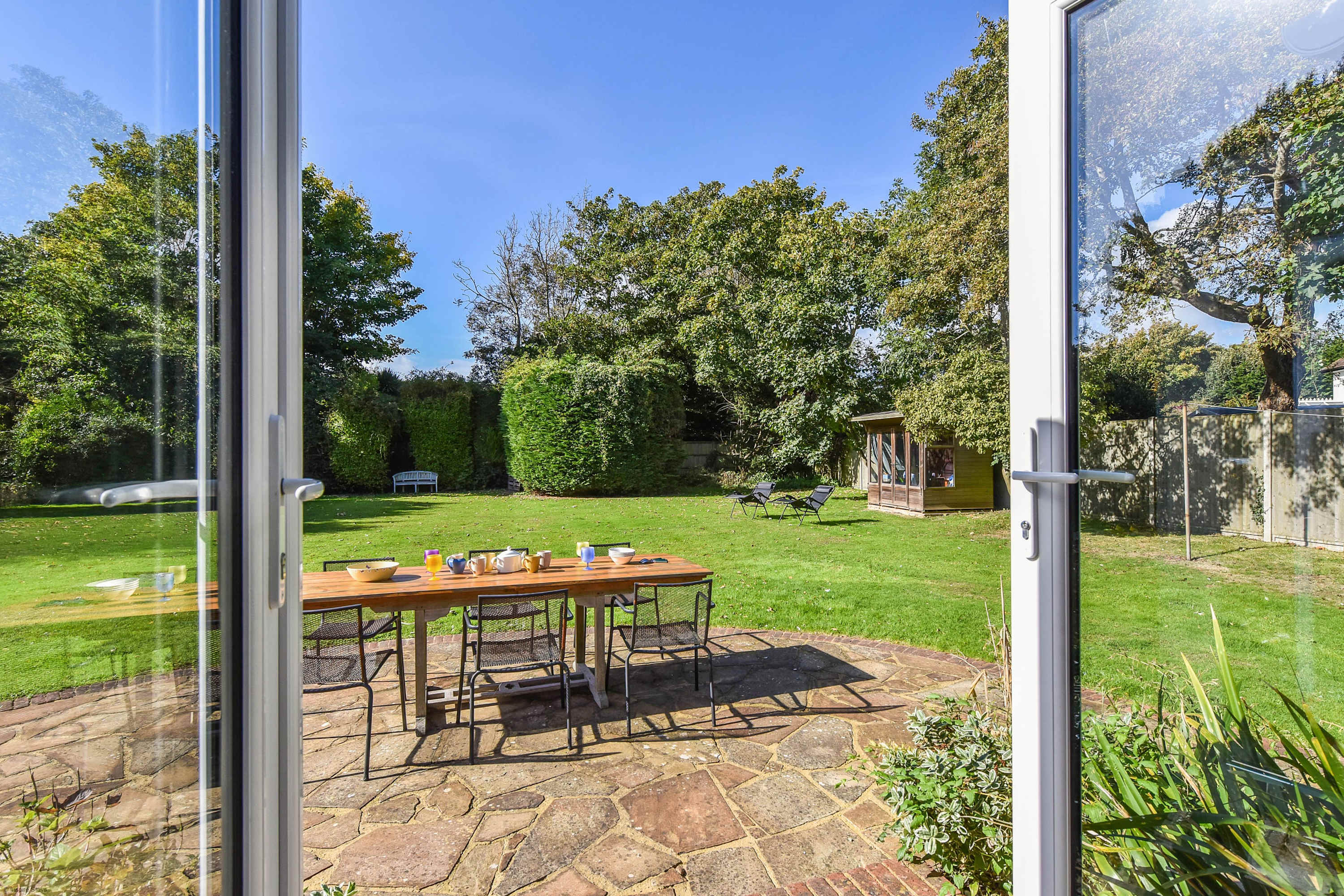 Kitchen doors open up onto the expansive lawn