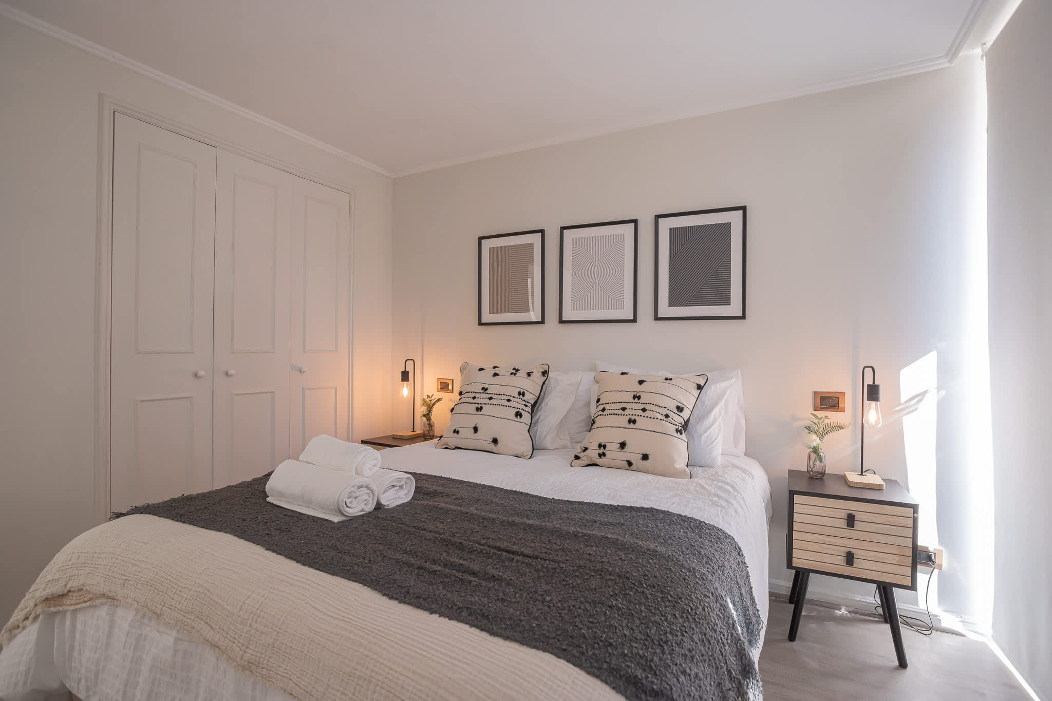 Unwind in this chic bedroom with cozy bedding, modern decor, and soothing lighting for a perfect retreat.