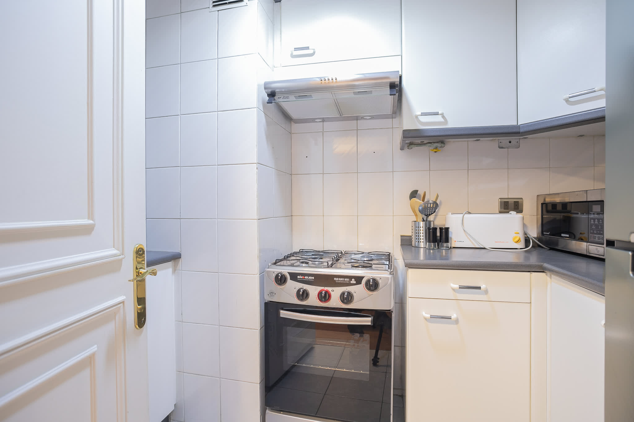 Modern kitchen with sleek appliances and ample storage, ideal for culinary enthusiasts.