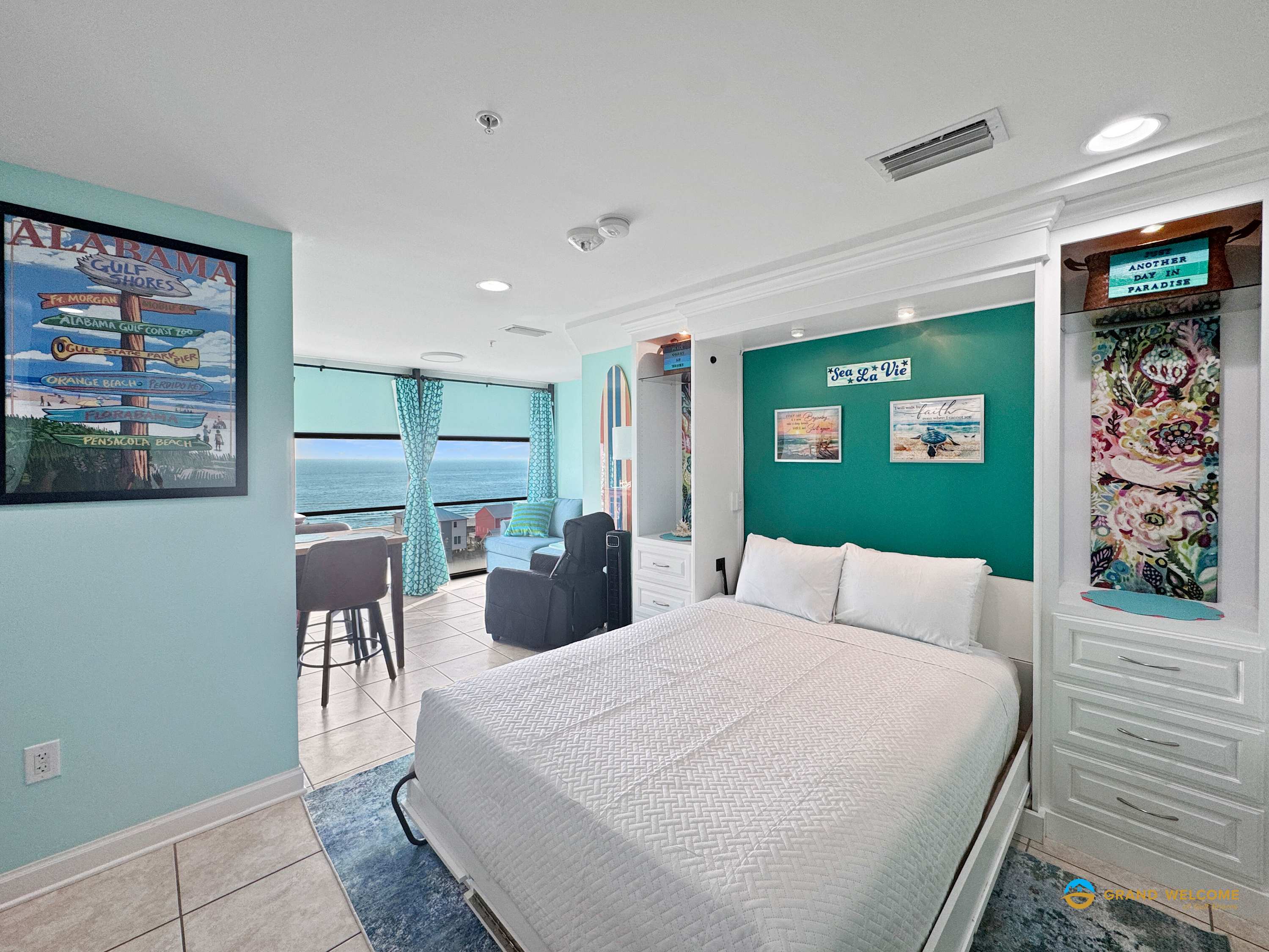 Cozy studio featuring a Murphy bed, dining tables, and kitchenette