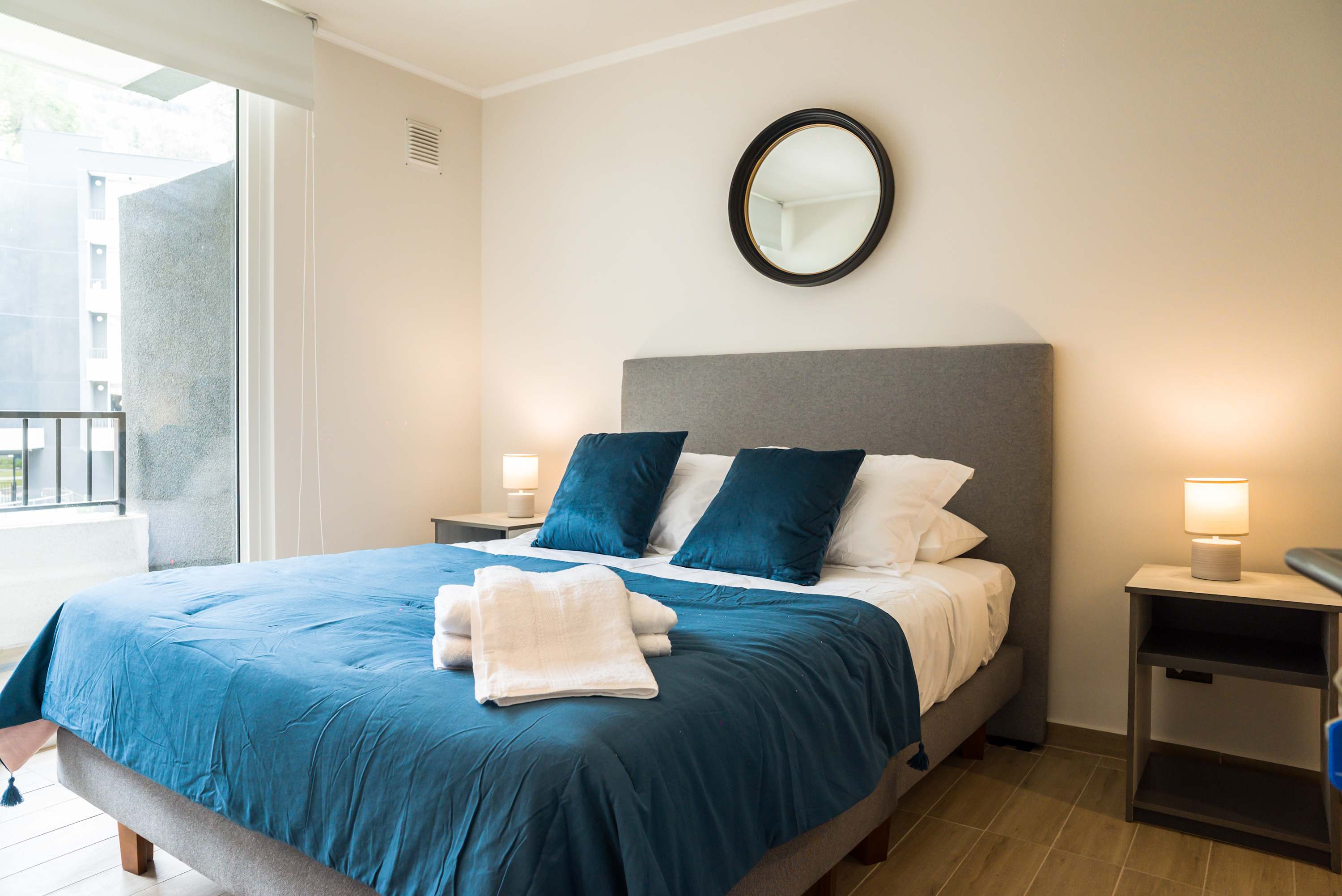 Cozy bedroom with plush bedding, ample natural light, and elegant decor for a restful stay.