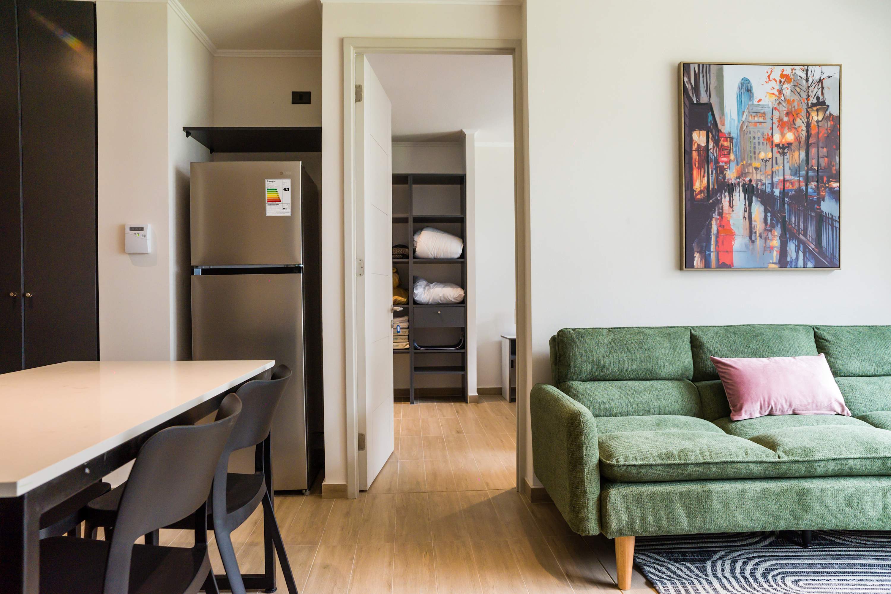 Inviting living area with modern decor and a comfy green sofa, perfect for unwinding after exploring the city.