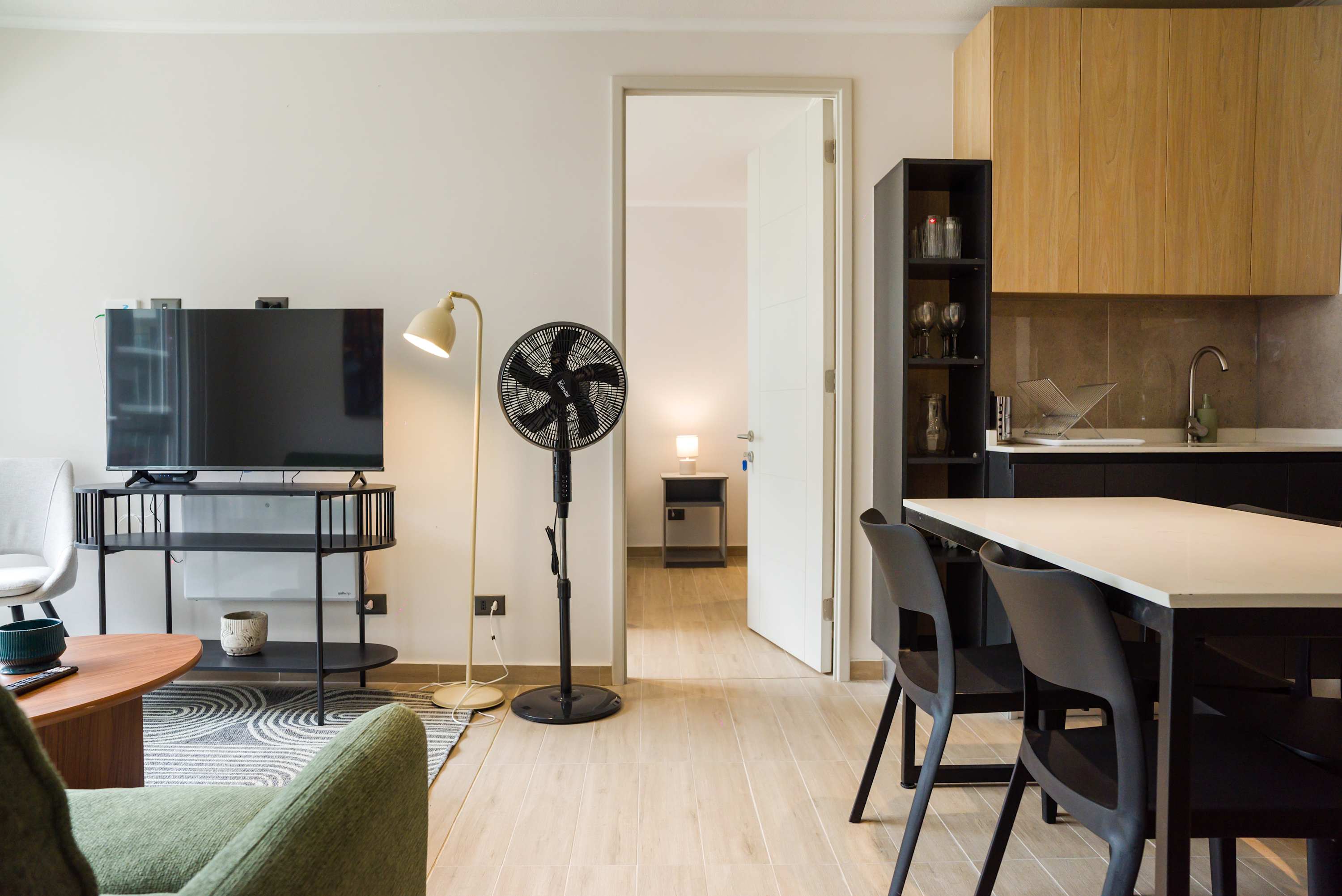 Modern living area with sleek kitchen and cozy seating, perfect for unwinding after city adventures.