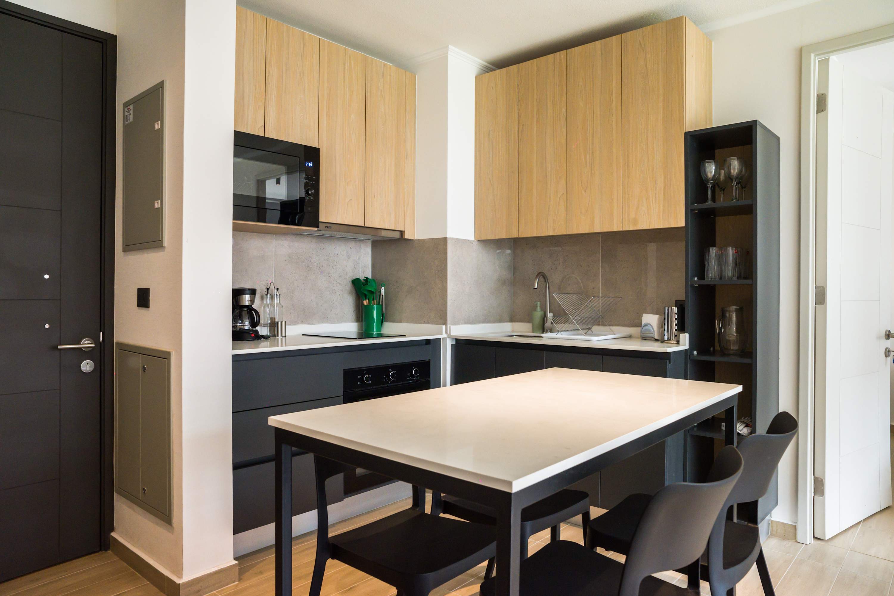 Modern kitchen with sleek design and ample dining space, perfect for enjoying home-cooked meals.