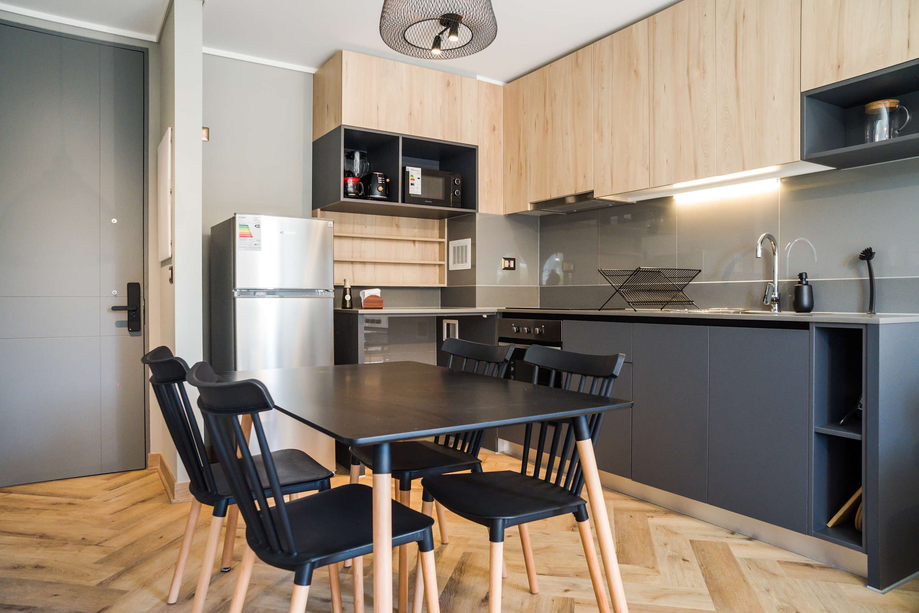Sleek and modern kitchen with ample storage and dining space, perfect for enjoying meals in comfort.