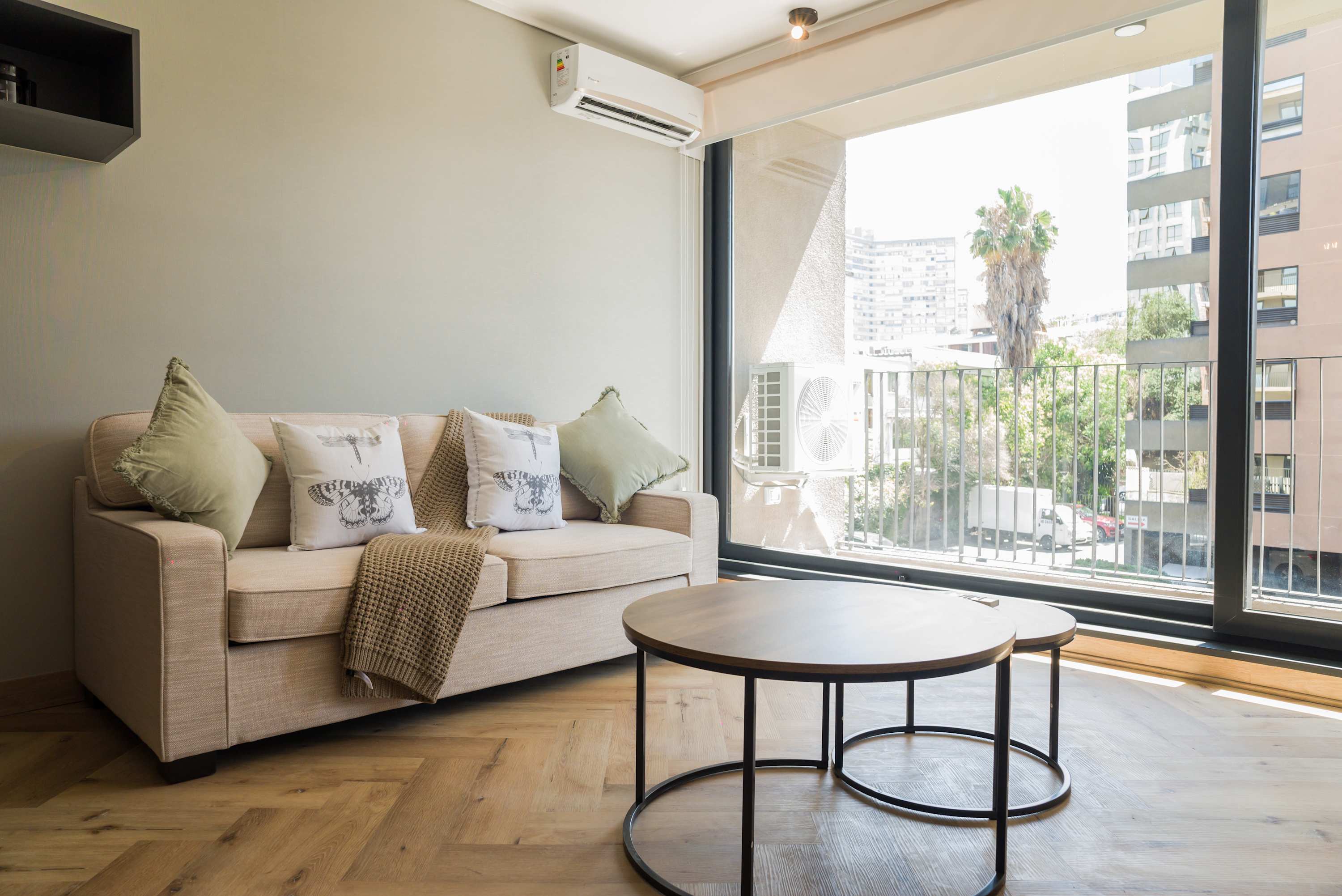Bright and cozy living area with city views, perfect for relaxation.