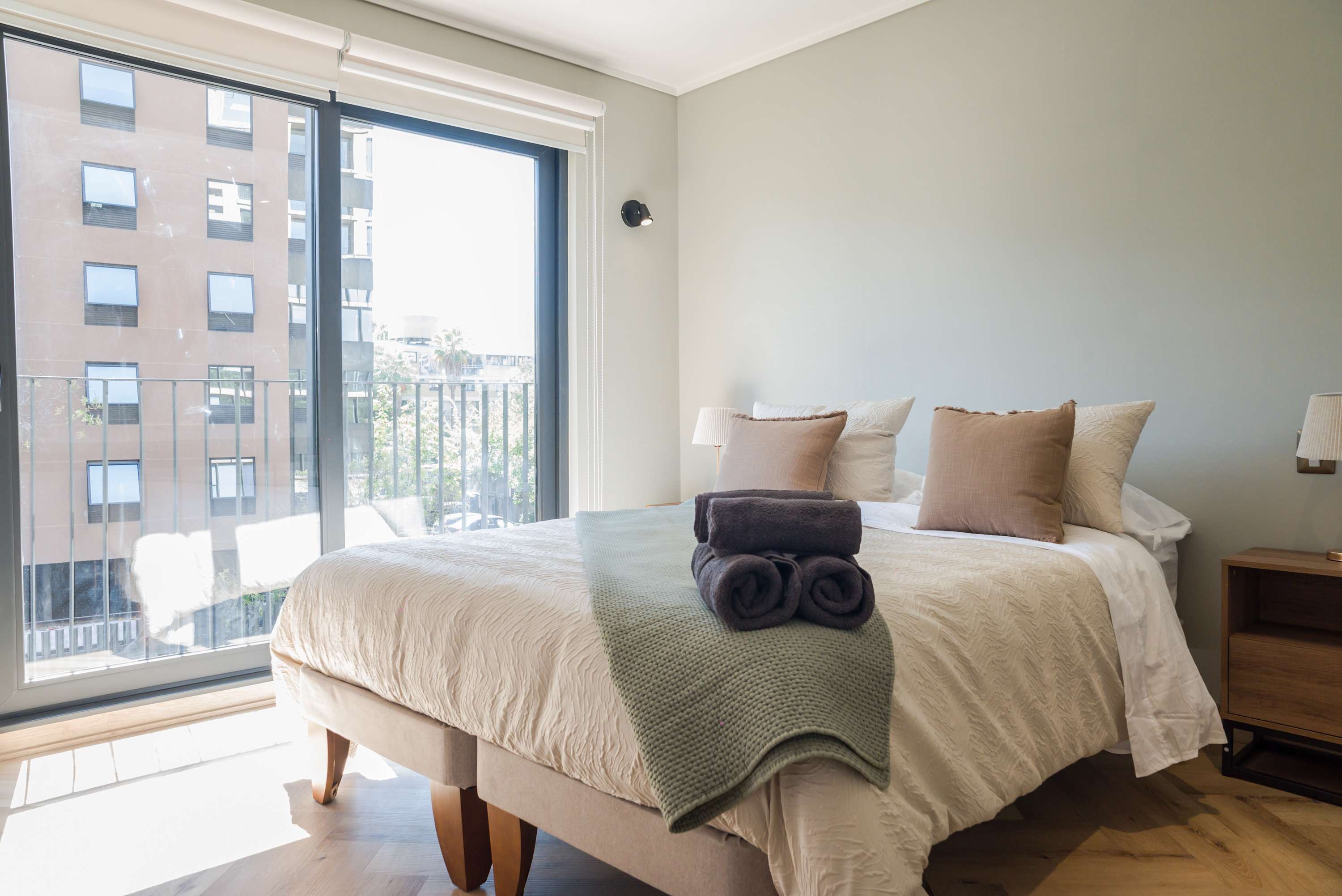 Relax in this cozy bedroom with abundant natural light and a comfortable bed, perfect for unwinding after exploring the city.