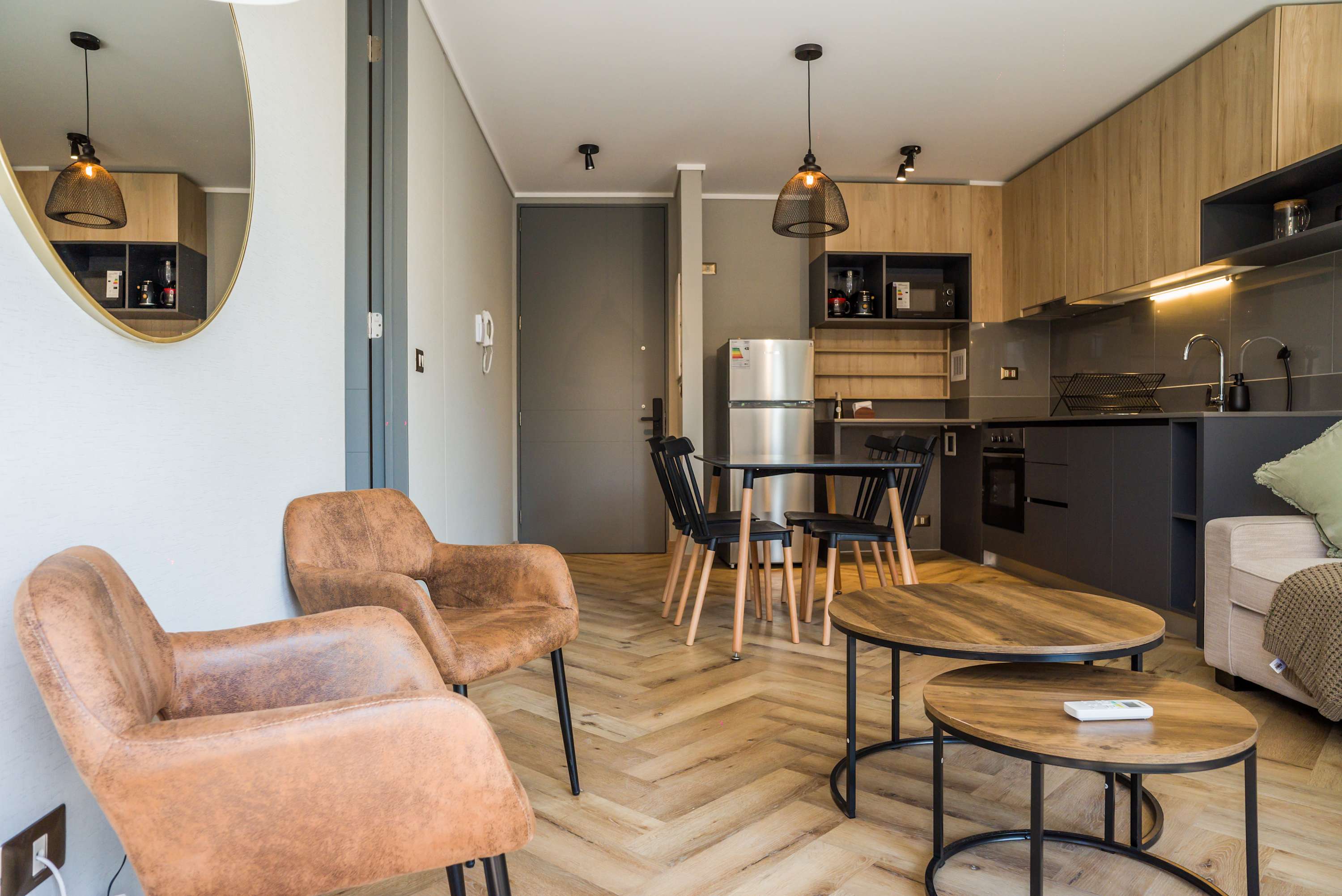 Stylish studio with a cozy living area and modern kitchen, perfect for a comfortable stay.