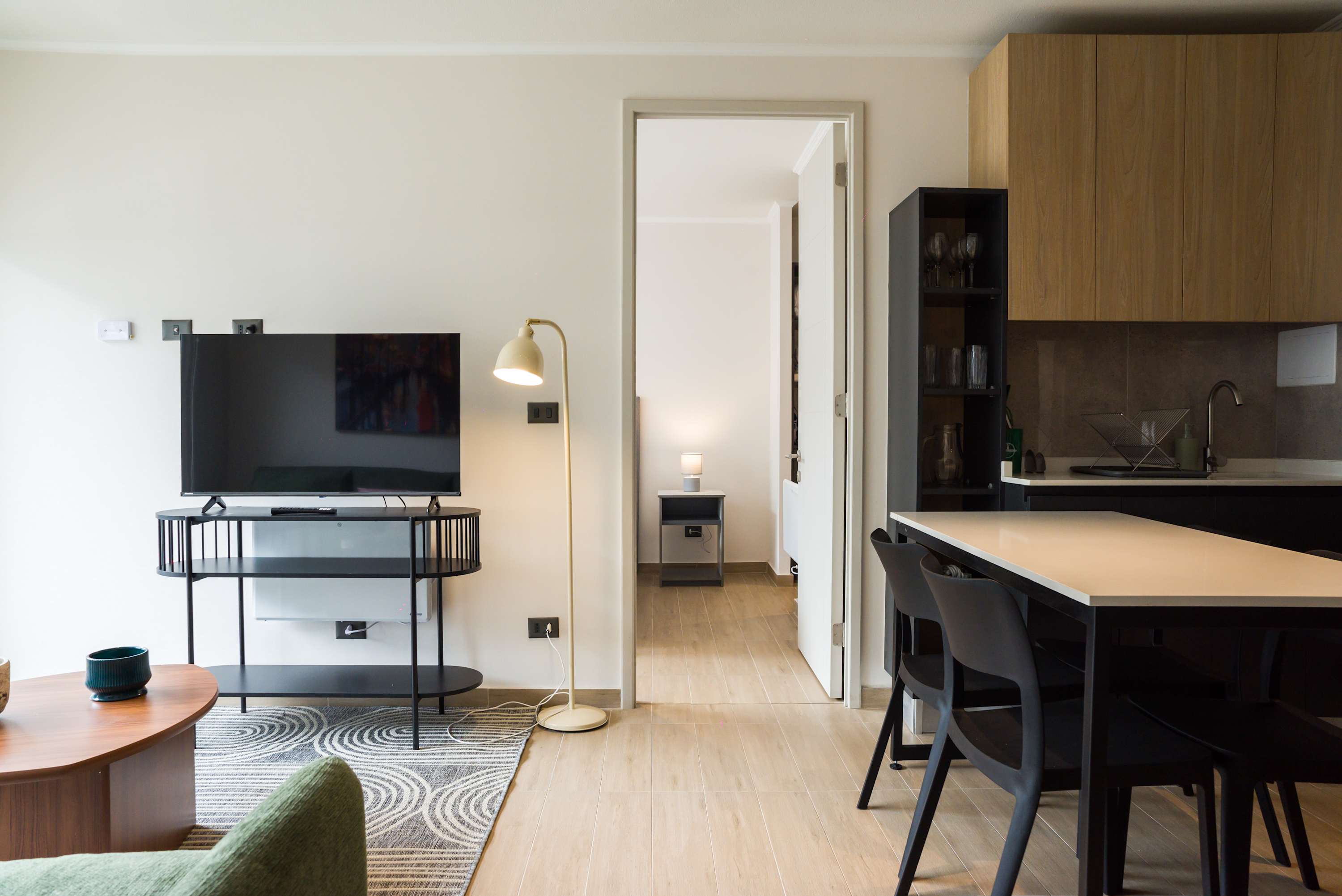 Cozy living area with modern amenities and a seamless flow into the bedroom, perfect for relaxation.