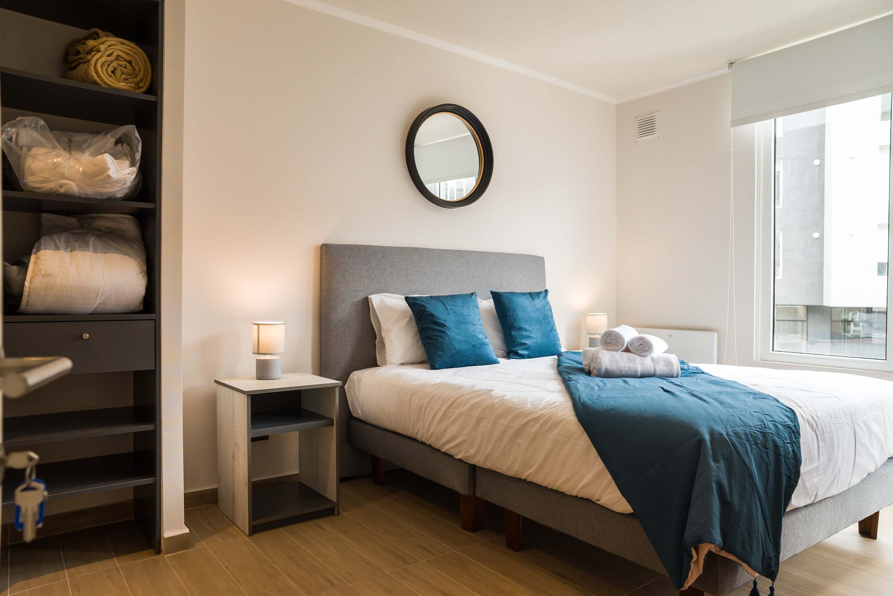 Relax in this cozy bedroom with natural light and plush bedding, perfect for unwinding after a day exploring the city.