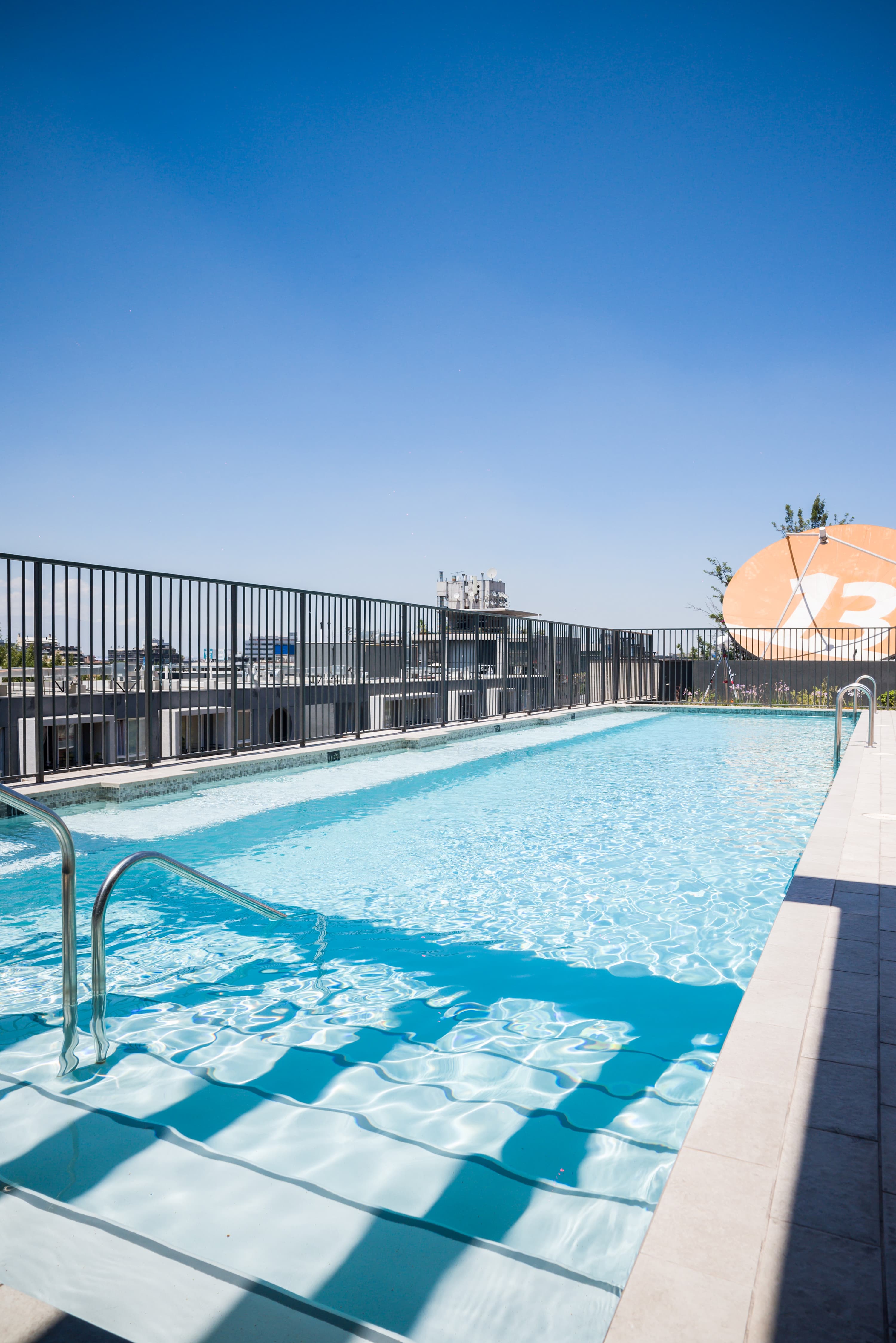 Enjoy a refreshing swim in the rooftop pool with stunning city views.