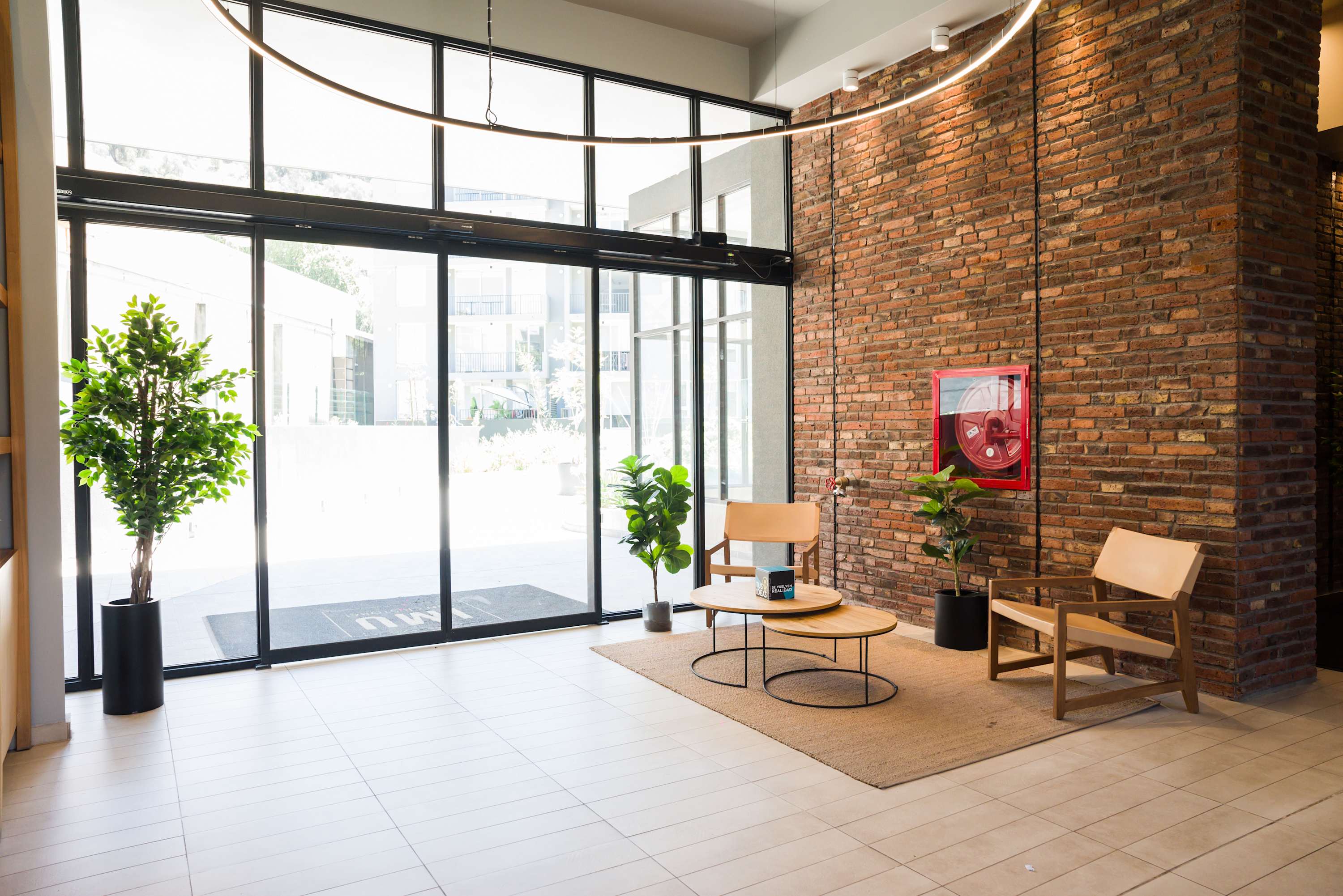 Modern lobby with natural light and cozy seating, ideal for relaxation or meeting guests. (Common Area)