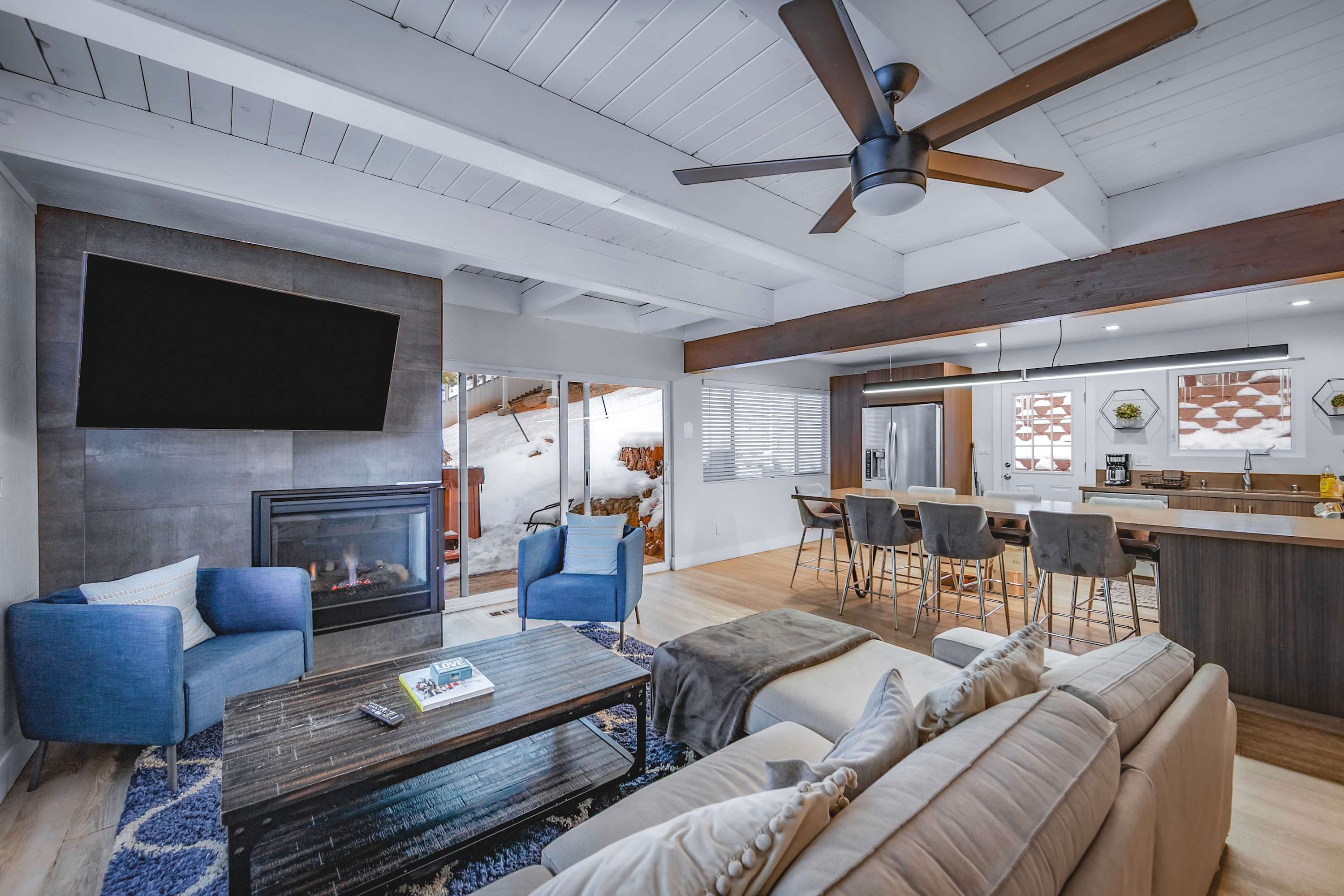 Living area with sectional sofa, gas fireplace, and Smart TV