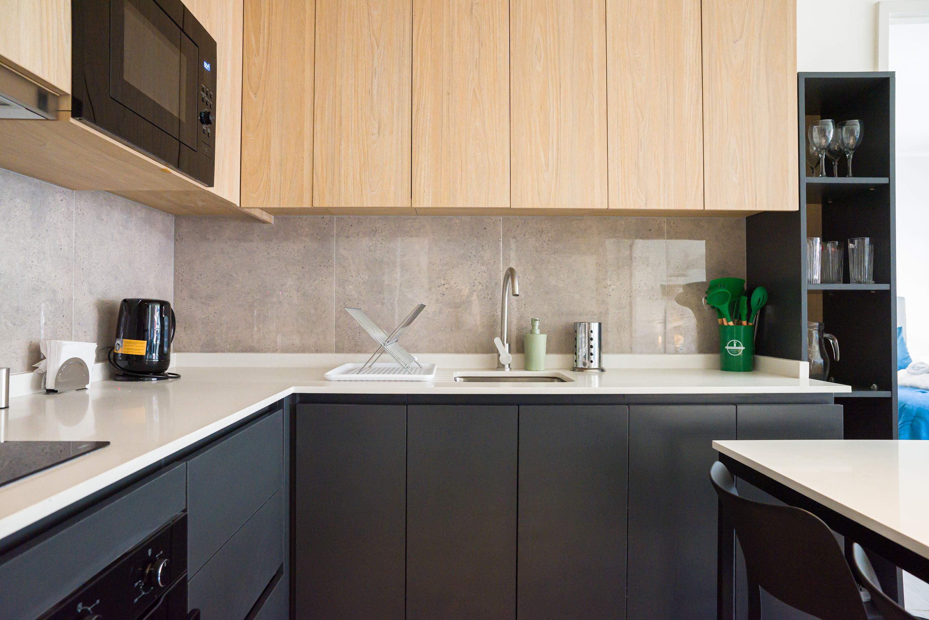 Sleek and modern kitchen with all essentials for a comfortable stay. Enjoy cooking in style with ample counter space and contemporary design.