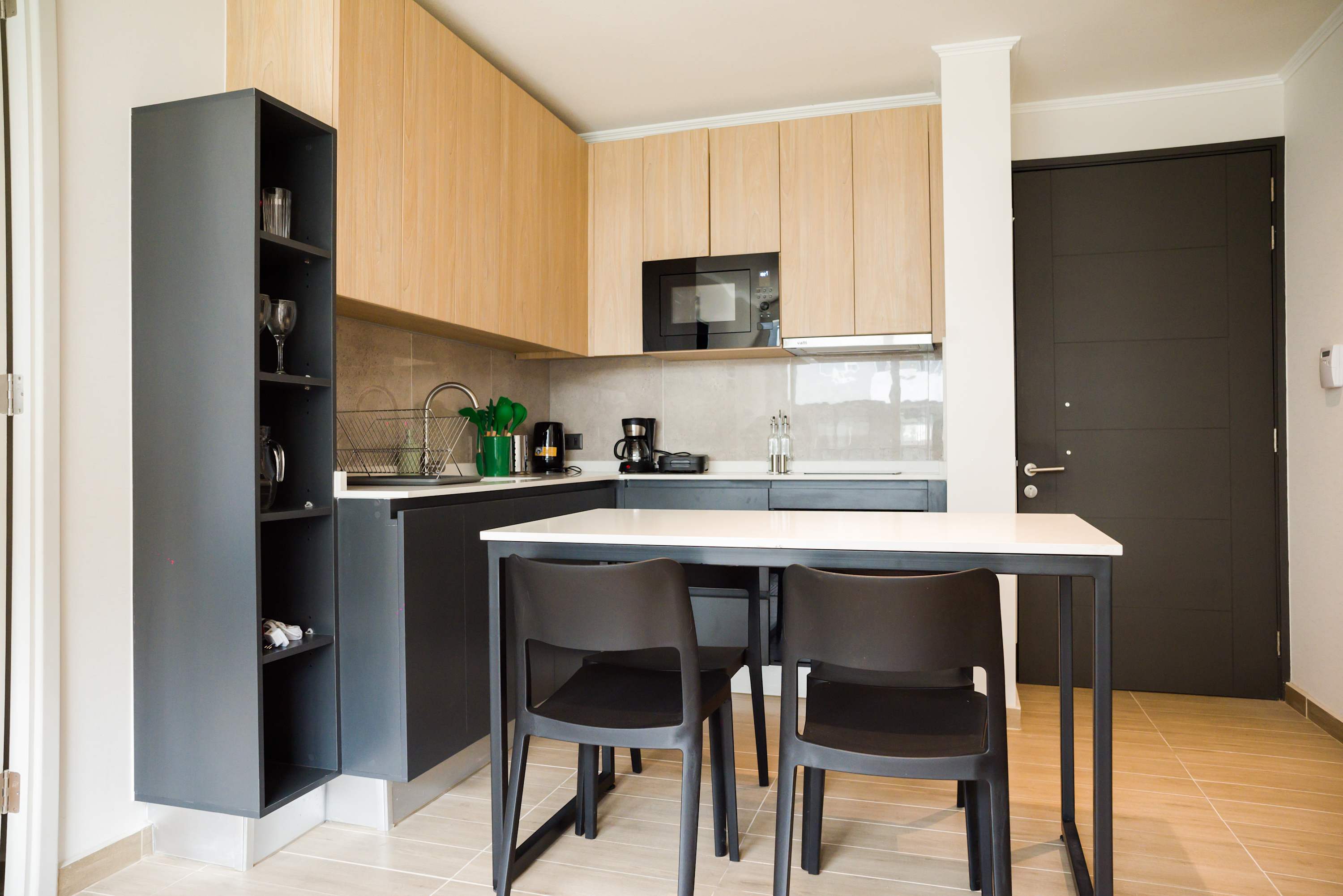 Modern kitchen with sleek design, perfect for cooking and dining in style during your stay.