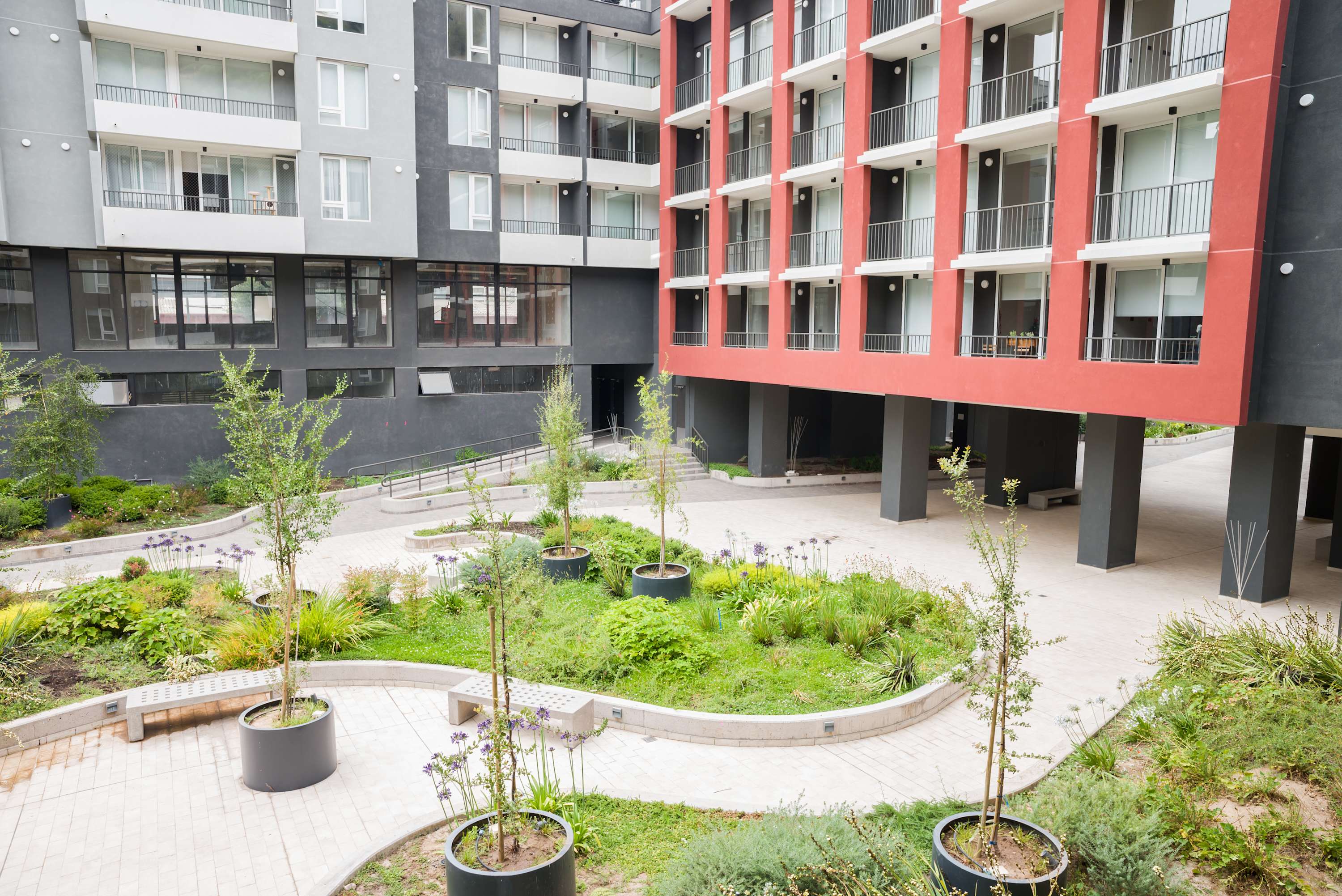 Enjoy the beautifully landscaped courtyard and modern architecture of this vibrant apartment complex.