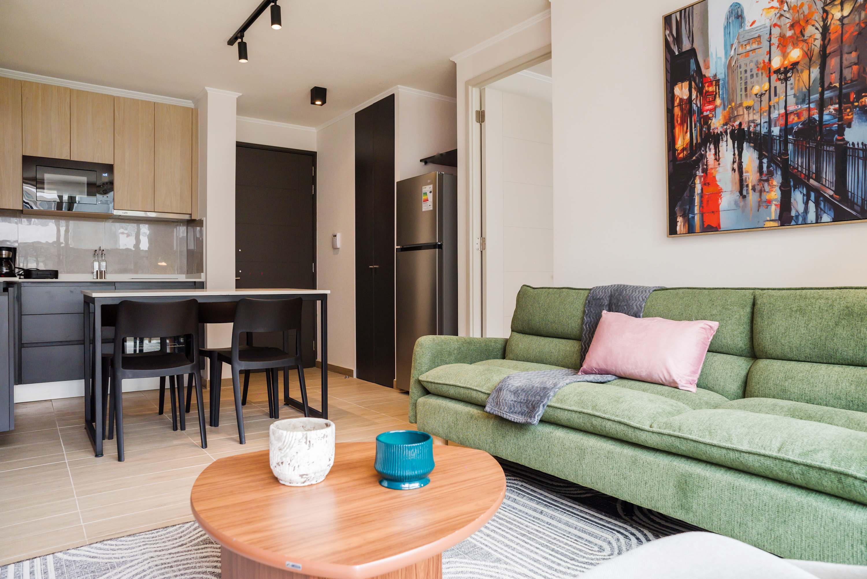 Cozy and stylish living area with vibrant decor and modern amenities, perfect for relaxation and dining.